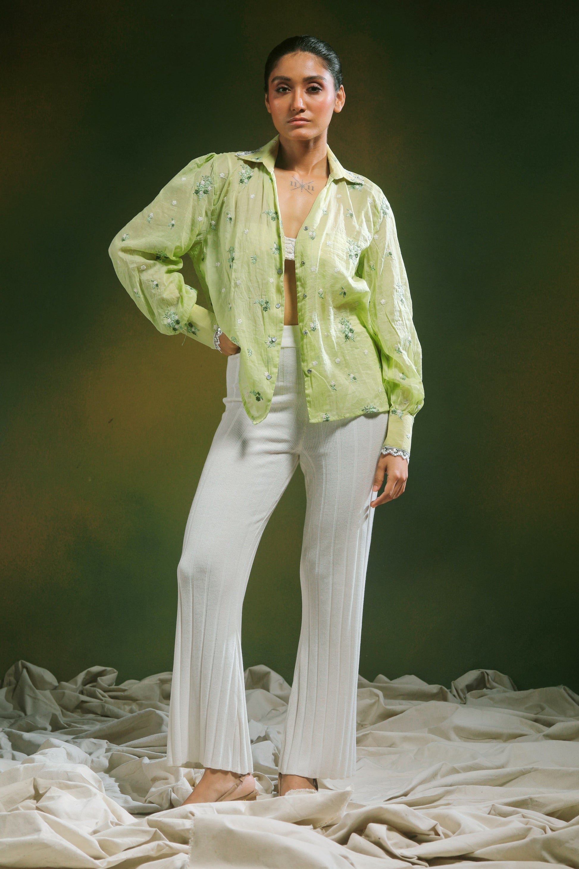 Light mint green oversized shirt by 66aura with a relaxed fit and long sleeves, shown on a model with casual styling.