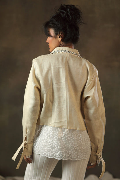 Oversized tan twist shirt by 66aura featuring a relaxed fit and textured twist fabric, displayed on a hanger against a neutral background.