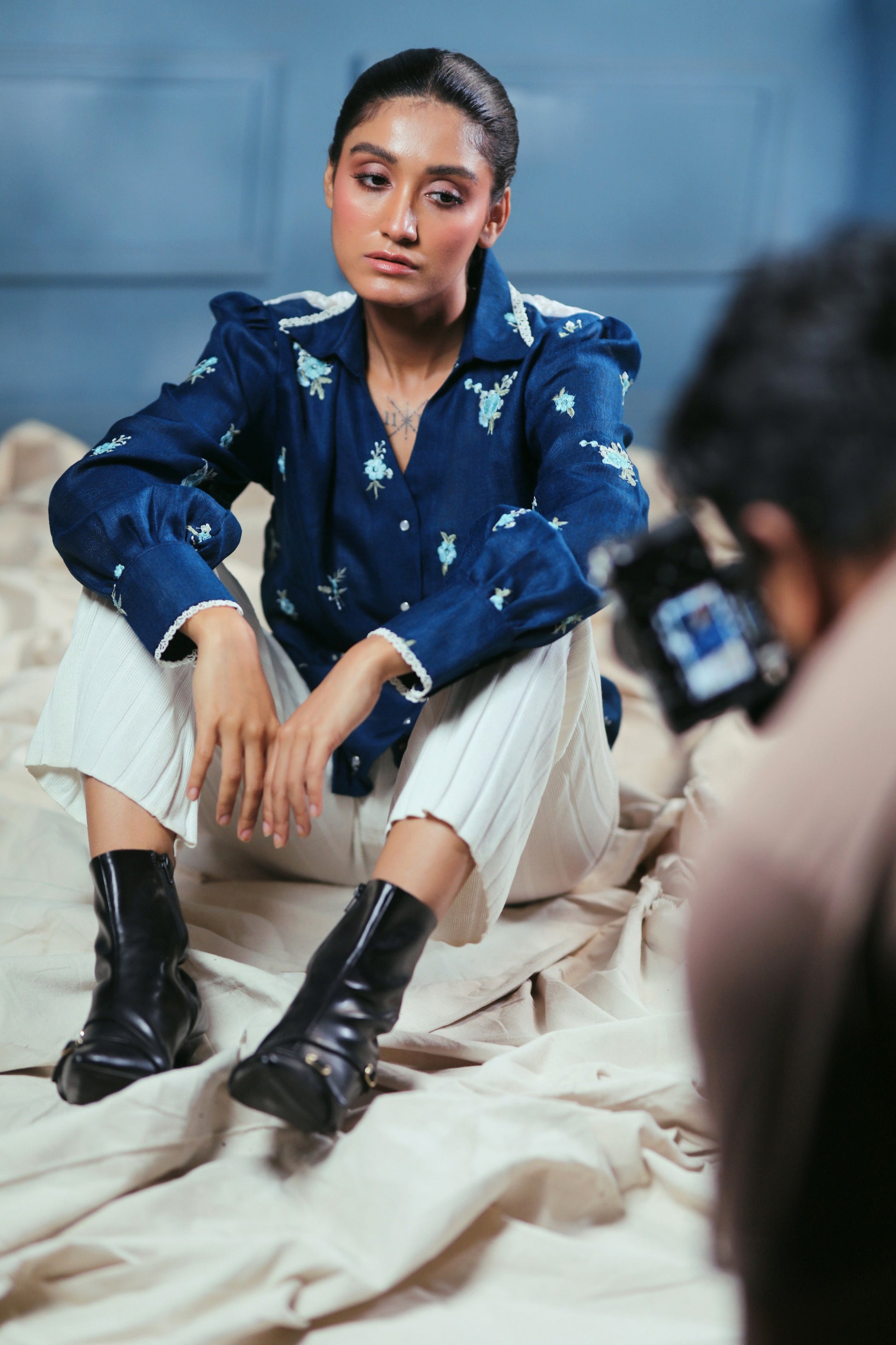 Navy Nexus oversized shirt by 66aura displayed on a hanger, featuring a relaxed fit and casual style.