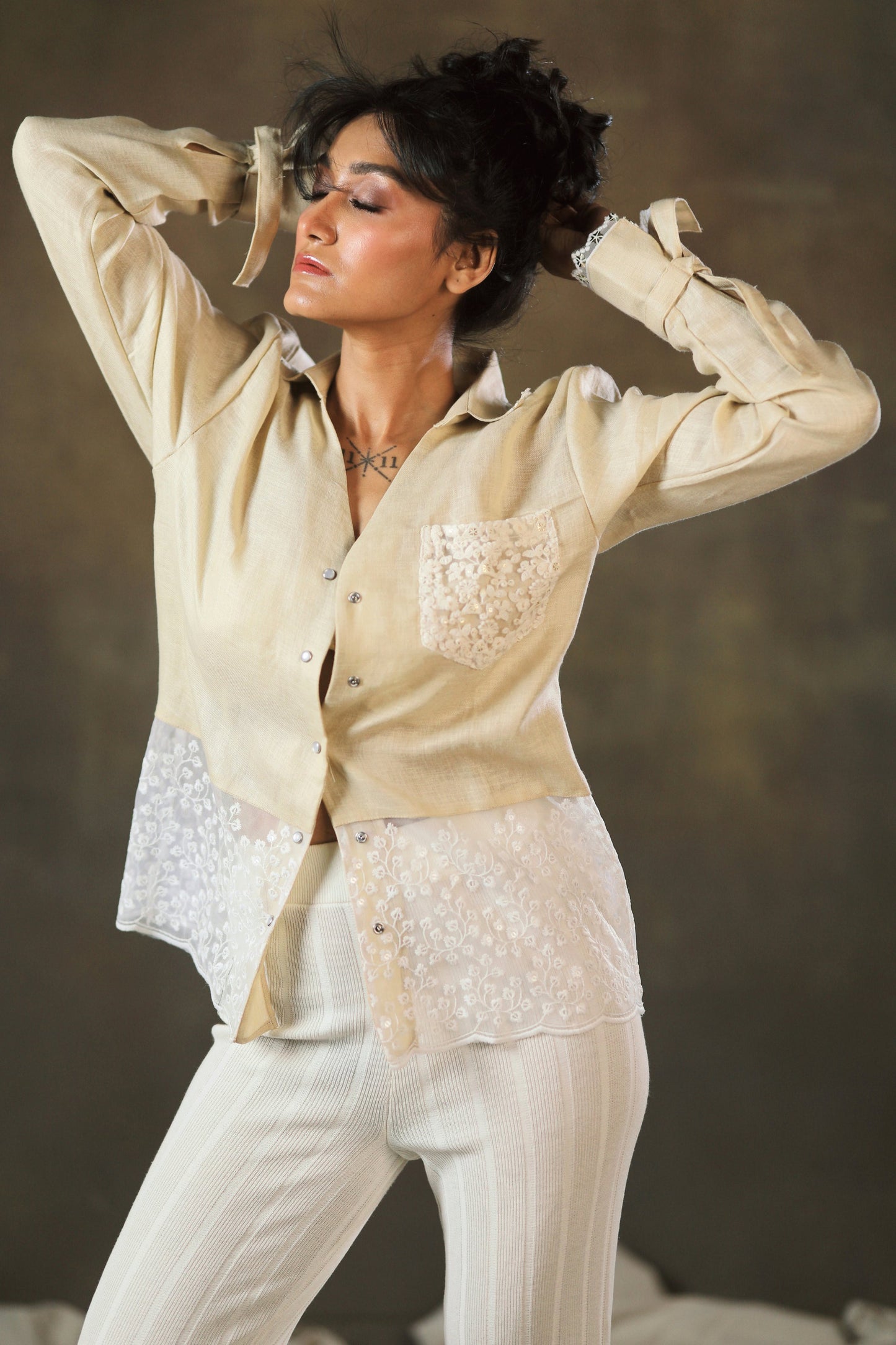 Tan Twist oversized shirt by 66aura, featuring a relaxed fit and soft fabric, displayed on a hanger against a neutral background.