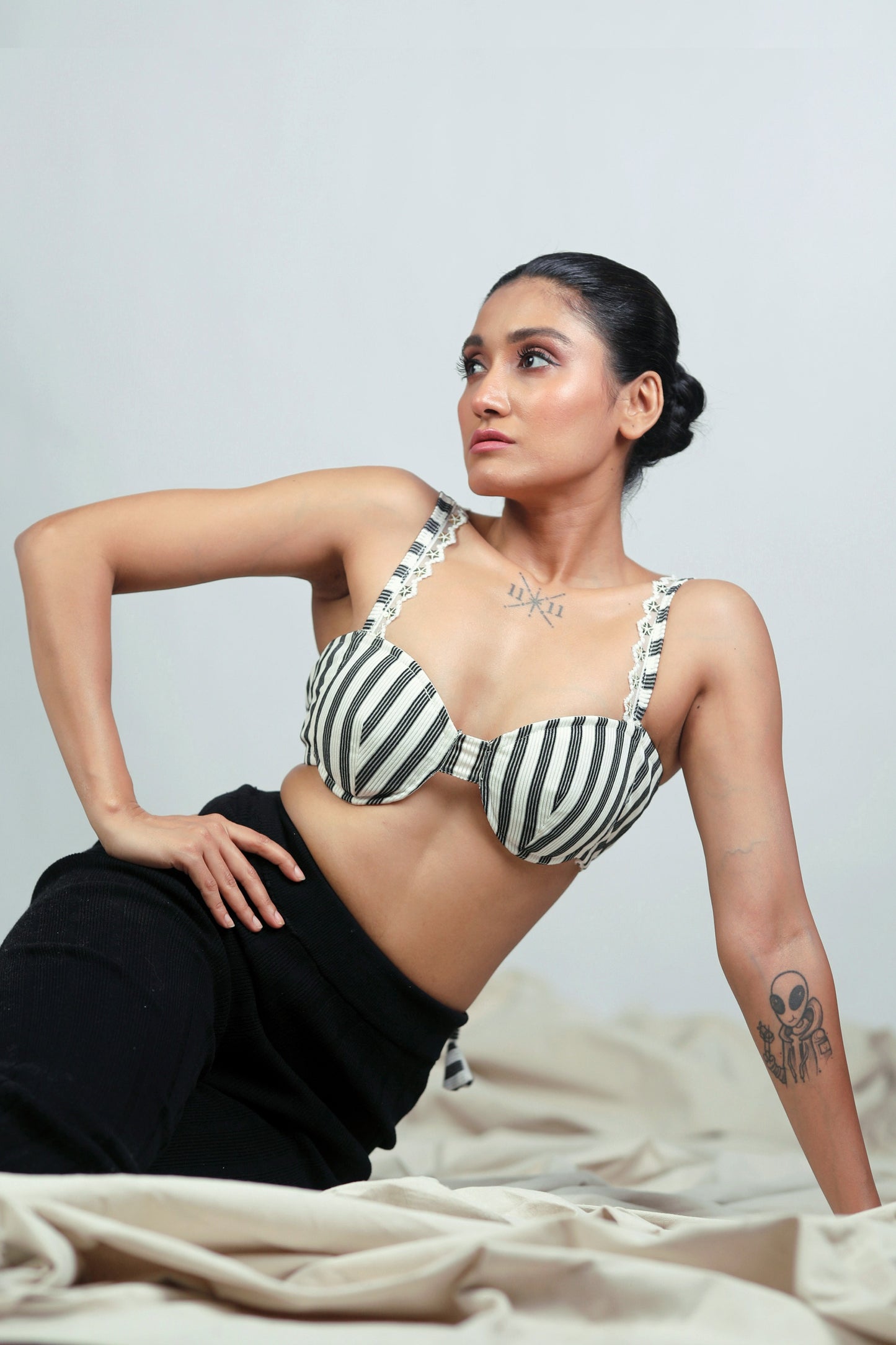 Power pinstripe bralette by 66aura featuring a sleek, fitted design with pinstripe pattern and adjustable straps.