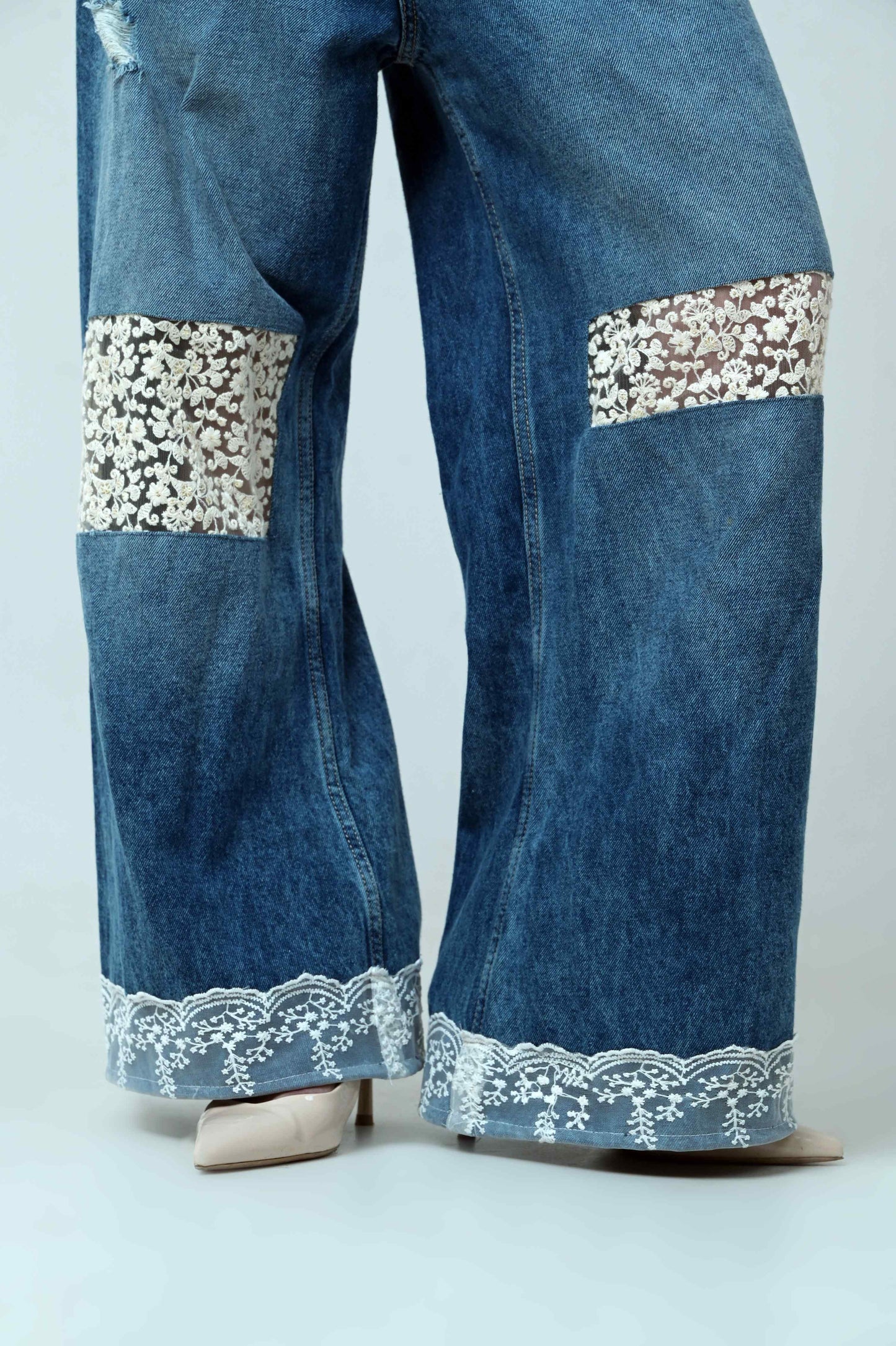 Light blue Vibe Check jeans by 66aura with a classic five-pocket design and slim fit, displayed on a hanger.