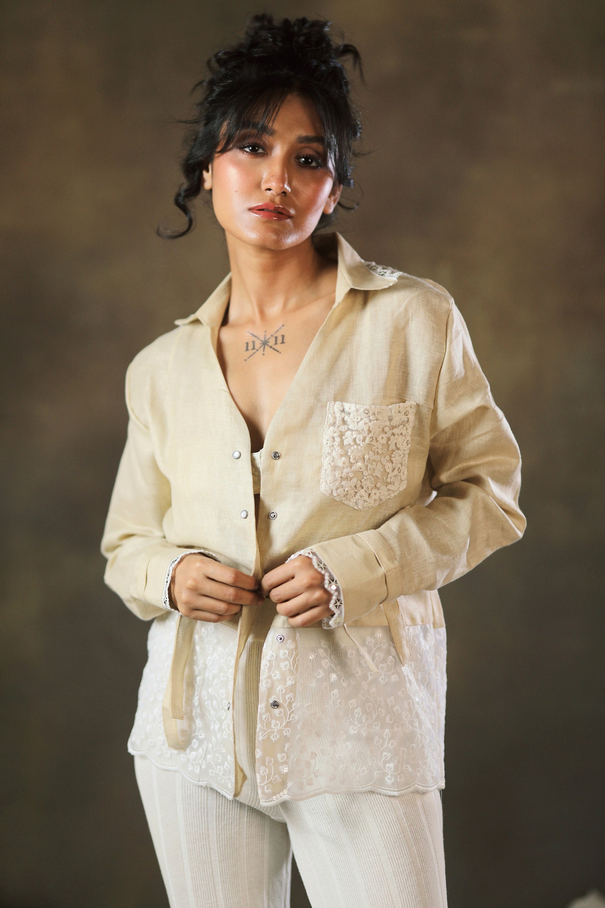 Tan oversized twist shirt by 66aura, showing the relaxed fit and twisted design on soft fabric in a casual style.