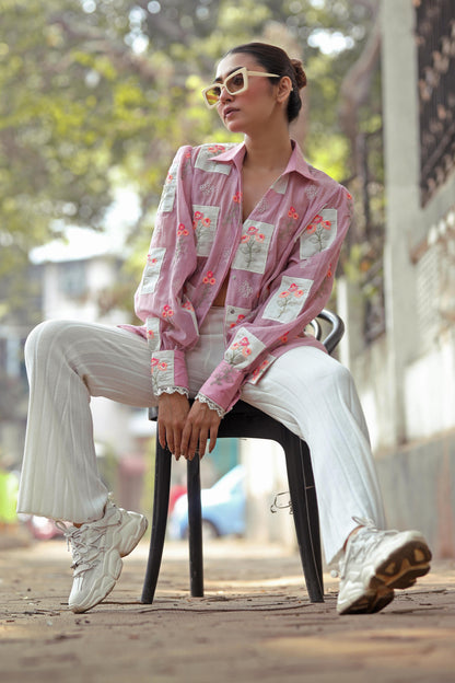 Lilac Loco Shirt by 66aura displayed on a hanger, showing its soft fabric and relaxed fit in a vibrant lilac color.