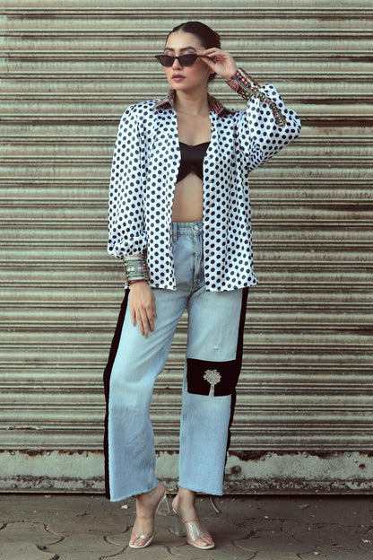 Close-up of the 66aura Plot Twist shirt featuring a graphic design with bold text and vibrant colors on soft fabric.