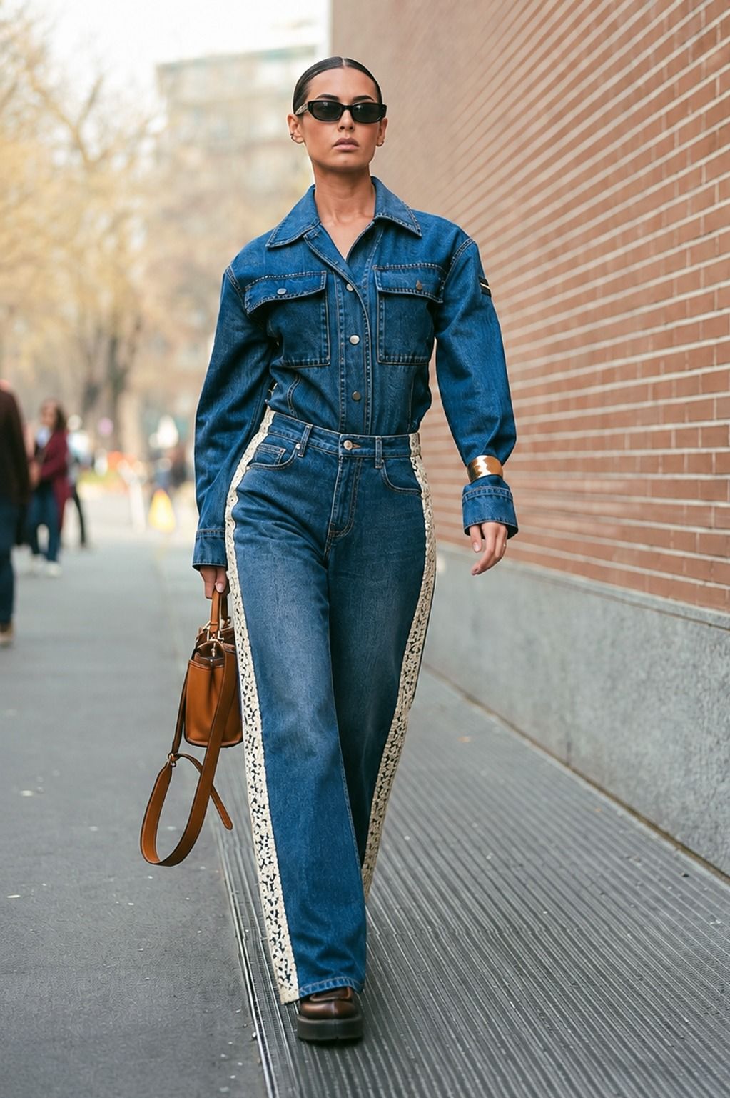 Pair of ROMCOM jeans by 66aura featuring classic denim fabric and a slim fit cut, displayed hanging on a wooden hanger.