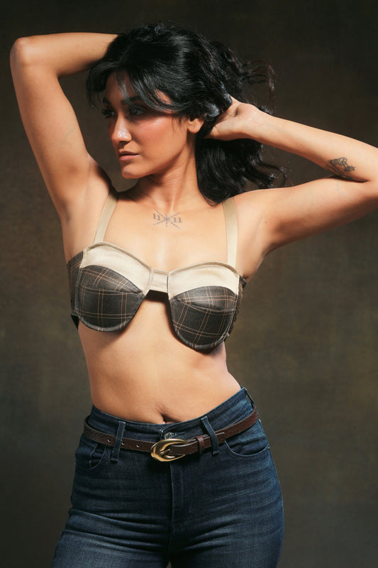 66aura Expresso Edge Bralette, close-up view showing black lace and delicate strap details on a soft fabric background.