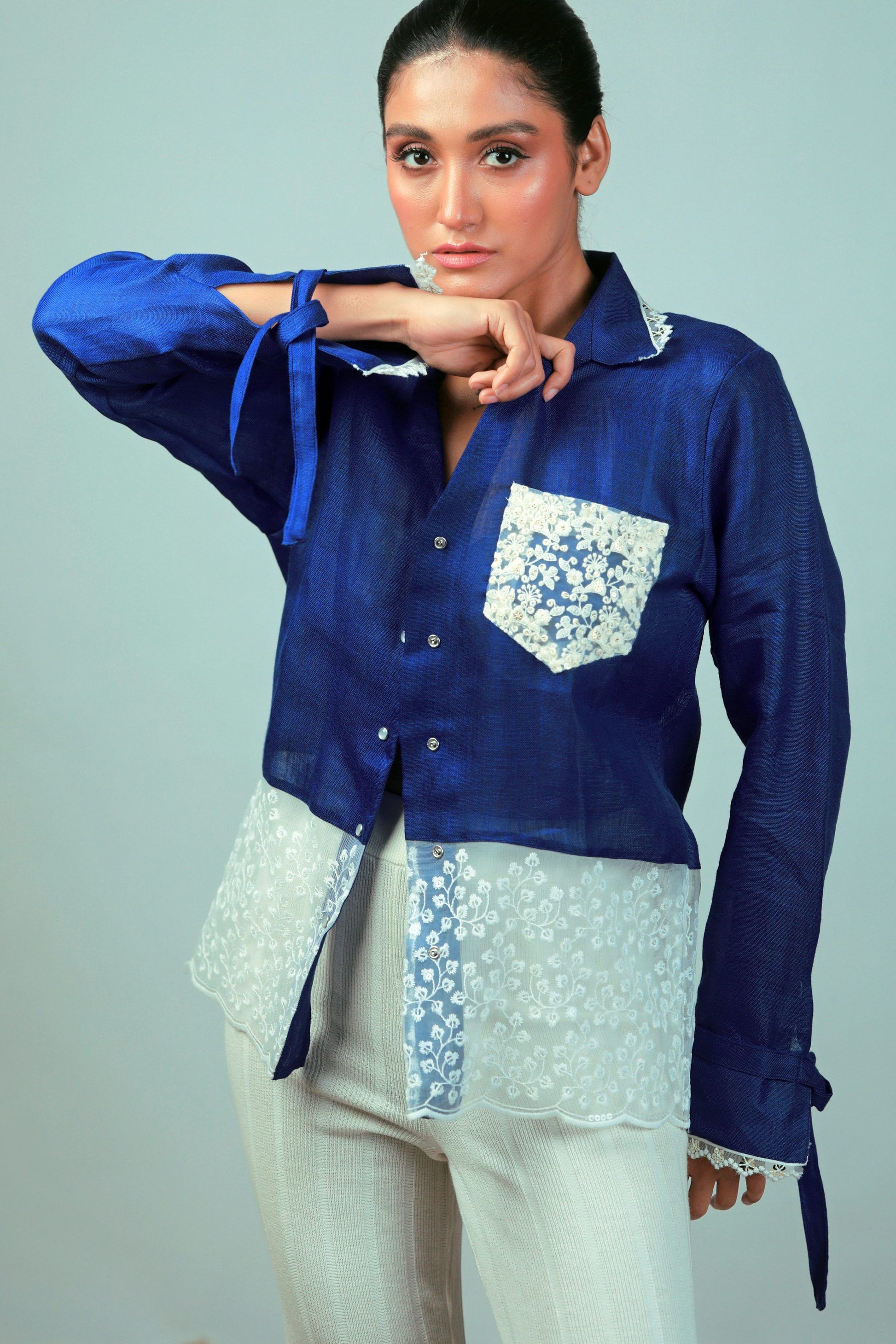 Cobalt Crush oversized shirt by 66aura shown hanging on a wooden hanger, featuring a relaxed fit and vibrant blue color.