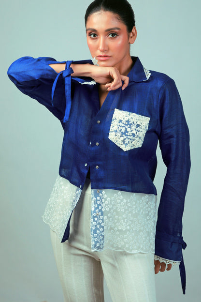 Cobalt Crush oversized shirt by 66aura shown hanging on a wooden hanger, featuring a relaxed fit and vibrant blue color.