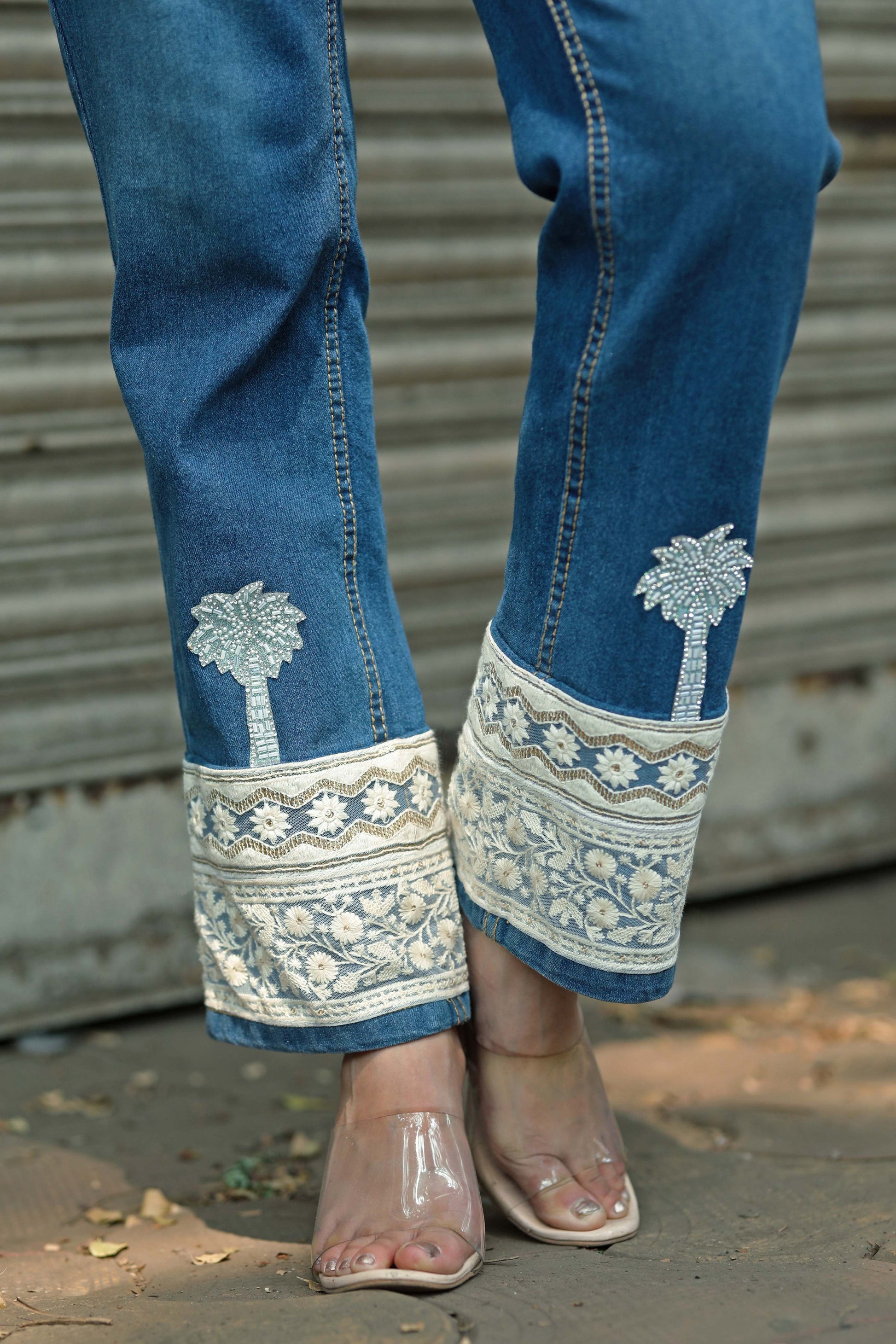Pair of HOT MESS jeans by 66aura featuring distressed denim and a relaxed fit on a model.