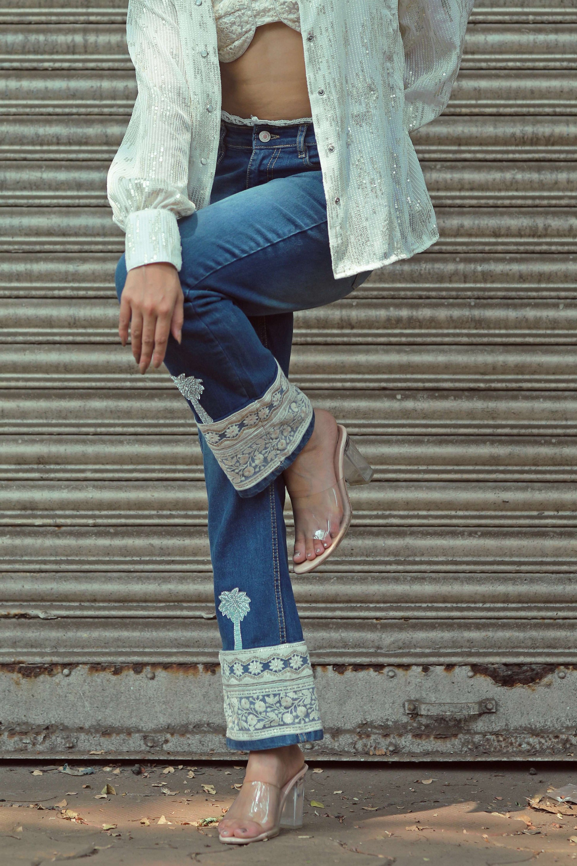 Pair of HOT MESS jeans by 66aura featuring distressed denim and a slim fit, shown on a model.