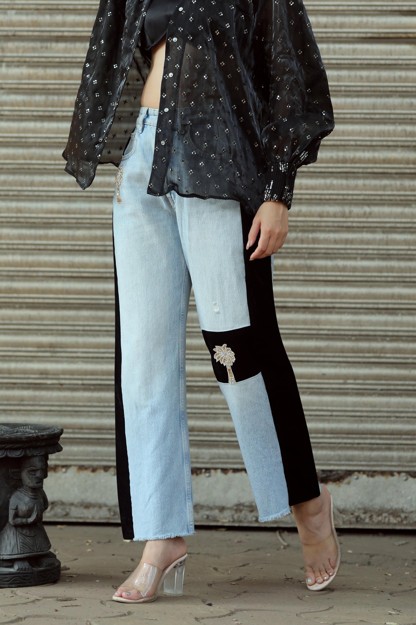 Light wash Boss Babe jeans by 66aura with a high-waisted fit and distressed details, styled with a casual top.