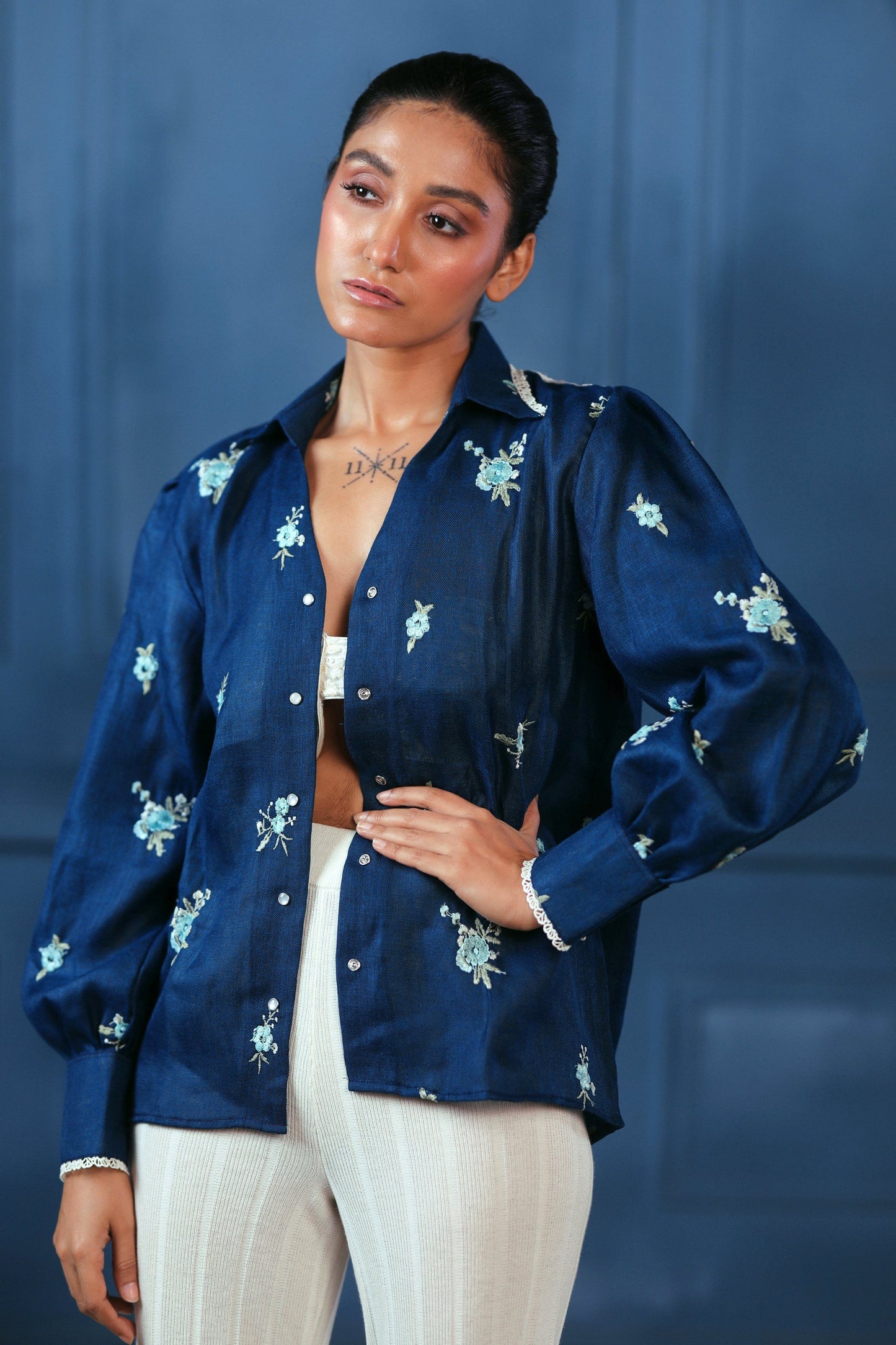 Navy Nexus oversized shirt by 66aura displayed on a hanger, featuring a relaxed fit and casual style with long sleeves.