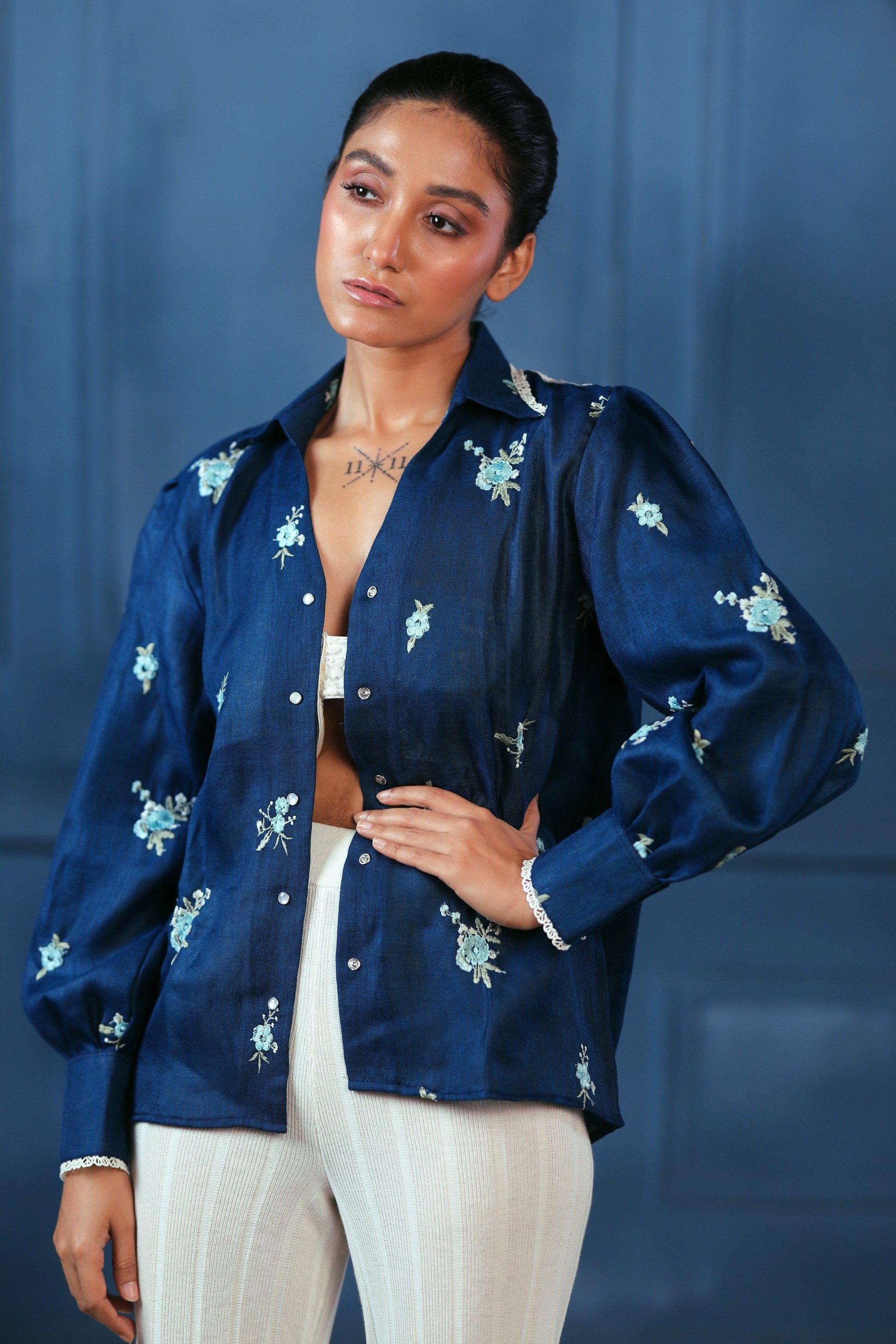 Navy Nexus oversized shirt by 66aura displayed on a hanger, featuring a relaxed fit and casual style with long sleeves.