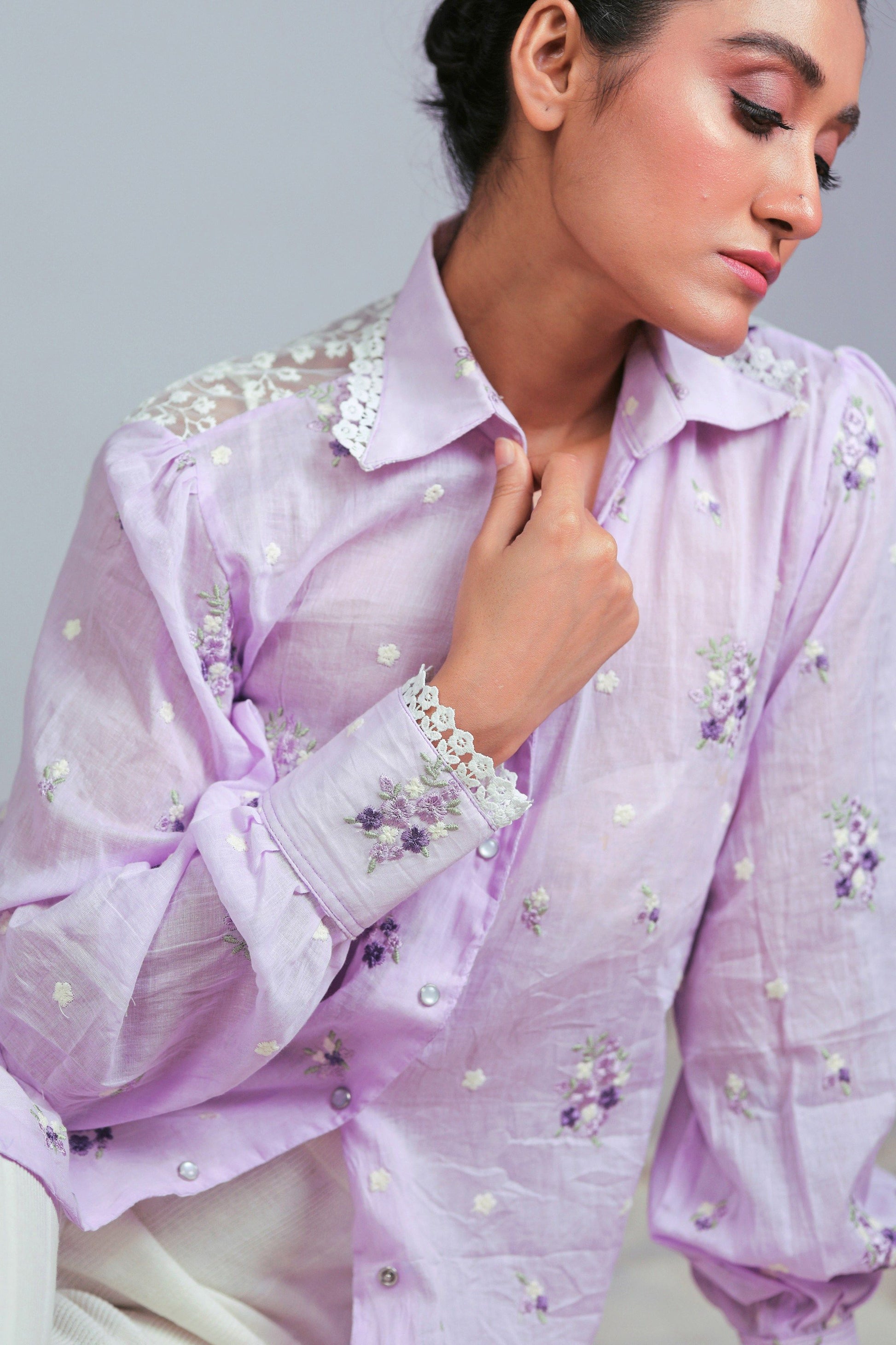 Lilac Lagoon oversized shirt by 66aura displayed on a hanger, showcasing its relaxed fit and soft fabric in a vivid lilac color.