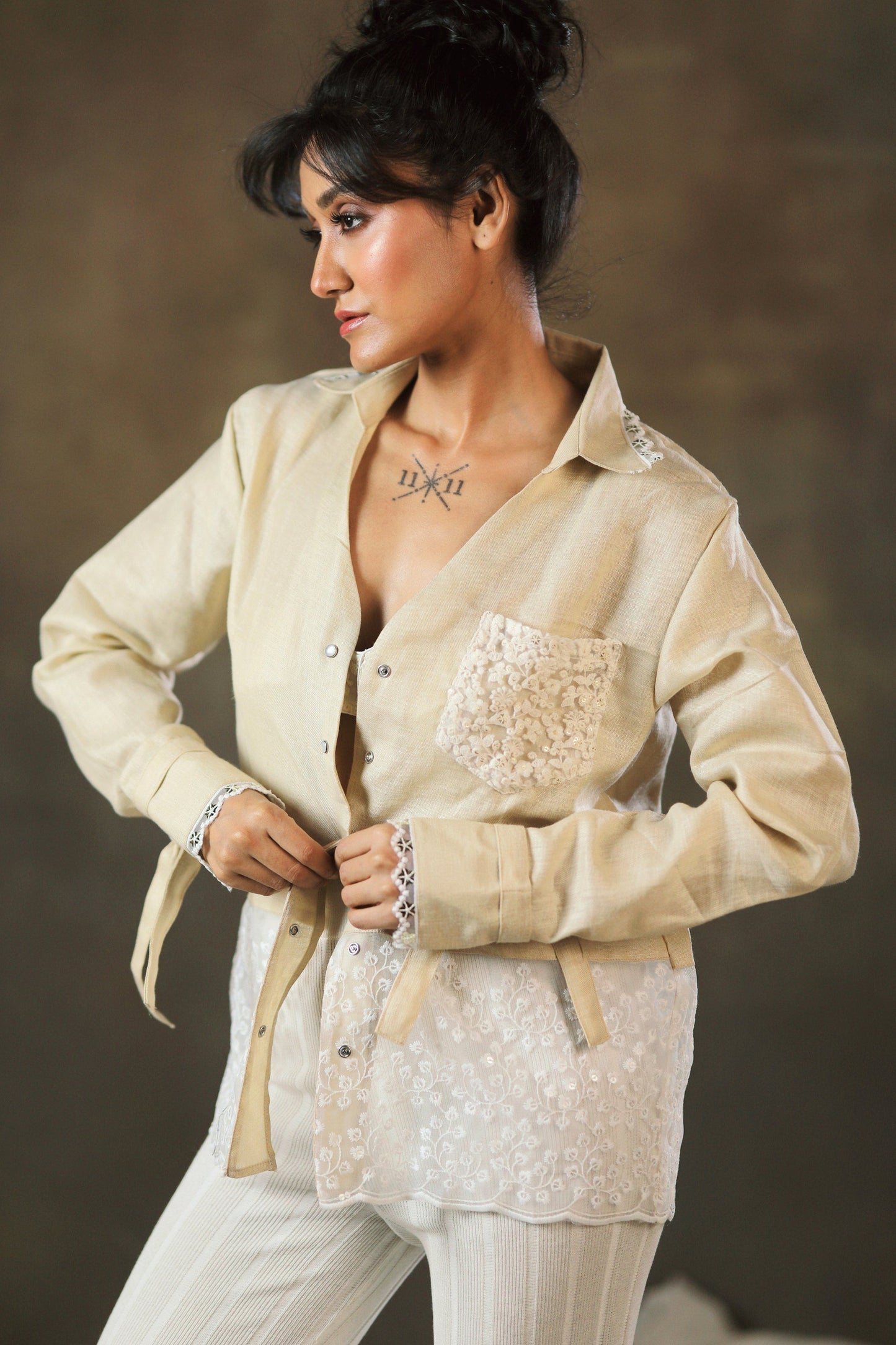 Tan twist oversized shirt by 66aura, featuring a relaxed fit with rolled-up sleeves and a casual, comfortable style.
