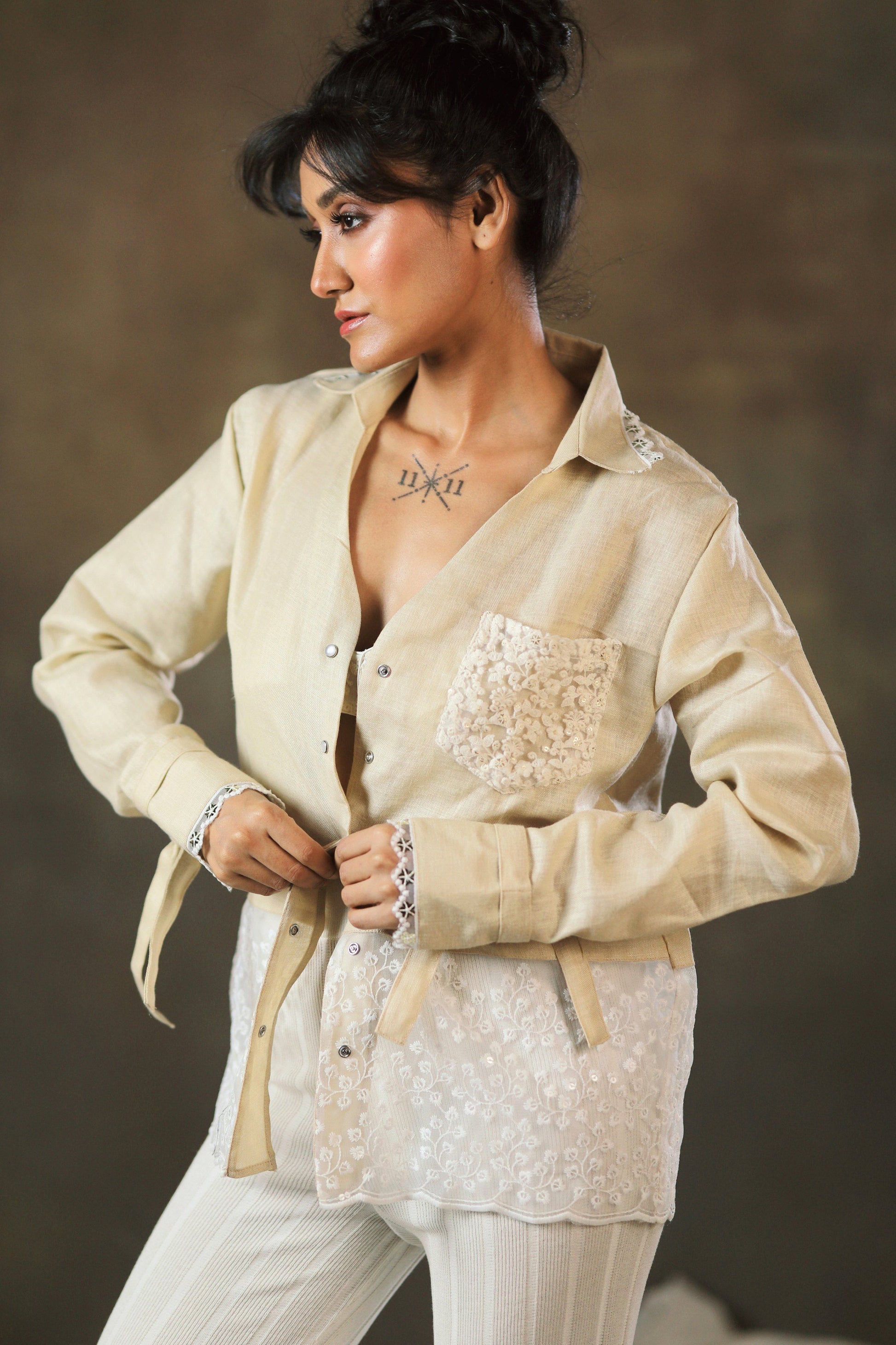 Tan twist oversized shirt by 66aura, featuring a relaxed fit with rolled-up sleeves and a casual, comfortable style.