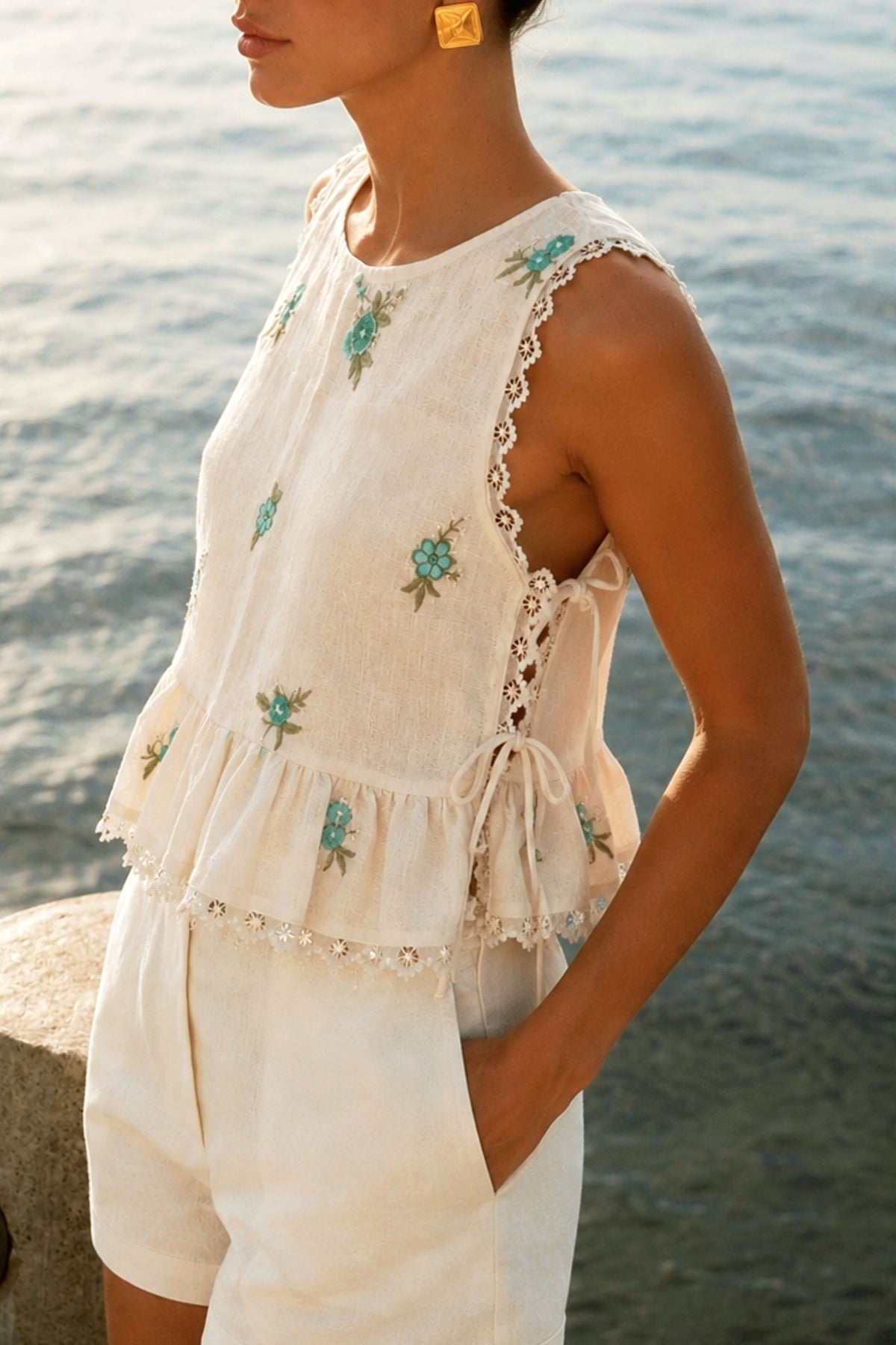 66aura Monaco Muse Top displayed on a hanger, featuring a stylish, lightweight fabric with a relaxed fit and fashionable neckline.
