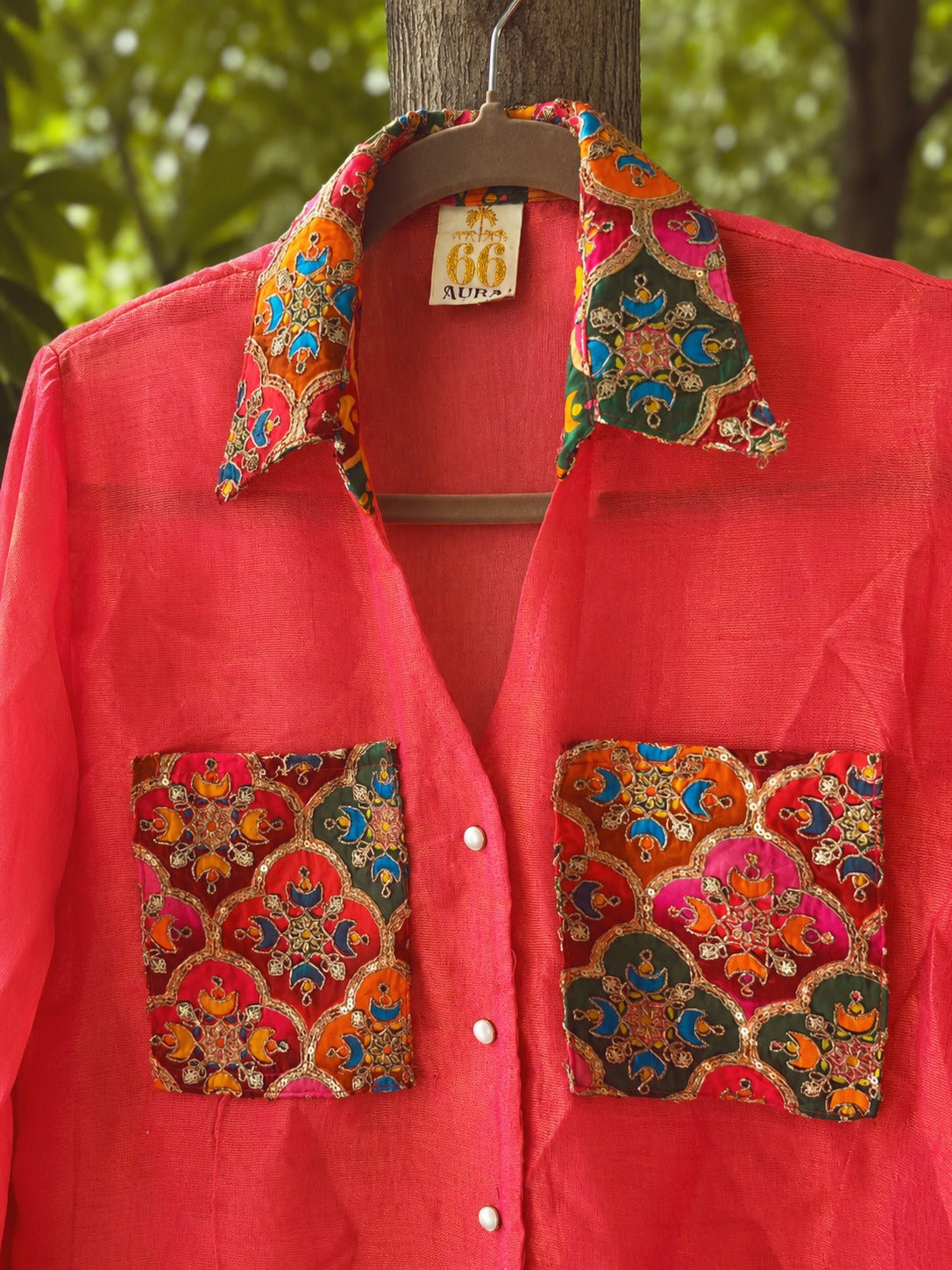 Oversized Mean Girl shirt by 66aura featuring bold graphic print, relaxed fit, and soft fabric, displayed on a hanger.