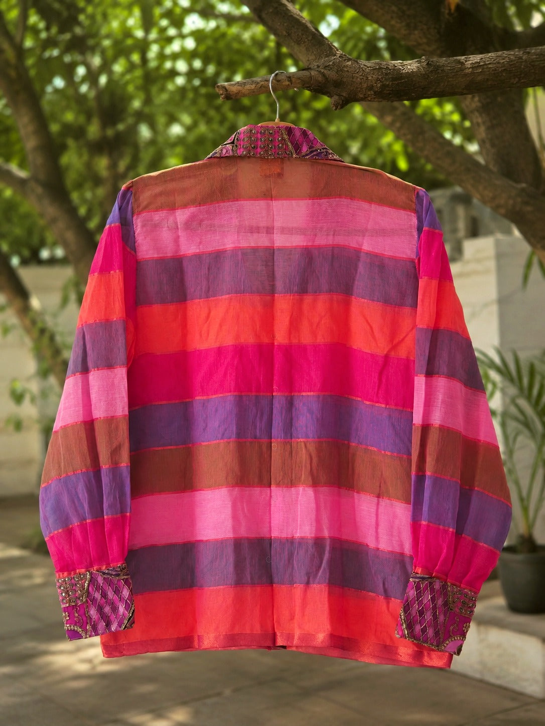 66aura Pixie Dust oversized shirt displayed on a hanger, featuring a relaxed fit with soft fabric and stylish design.