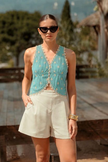 66aura Capri Coast Top featuring lightweight fabric, stylish design, and a relaxed fit, showcased on a hanger.