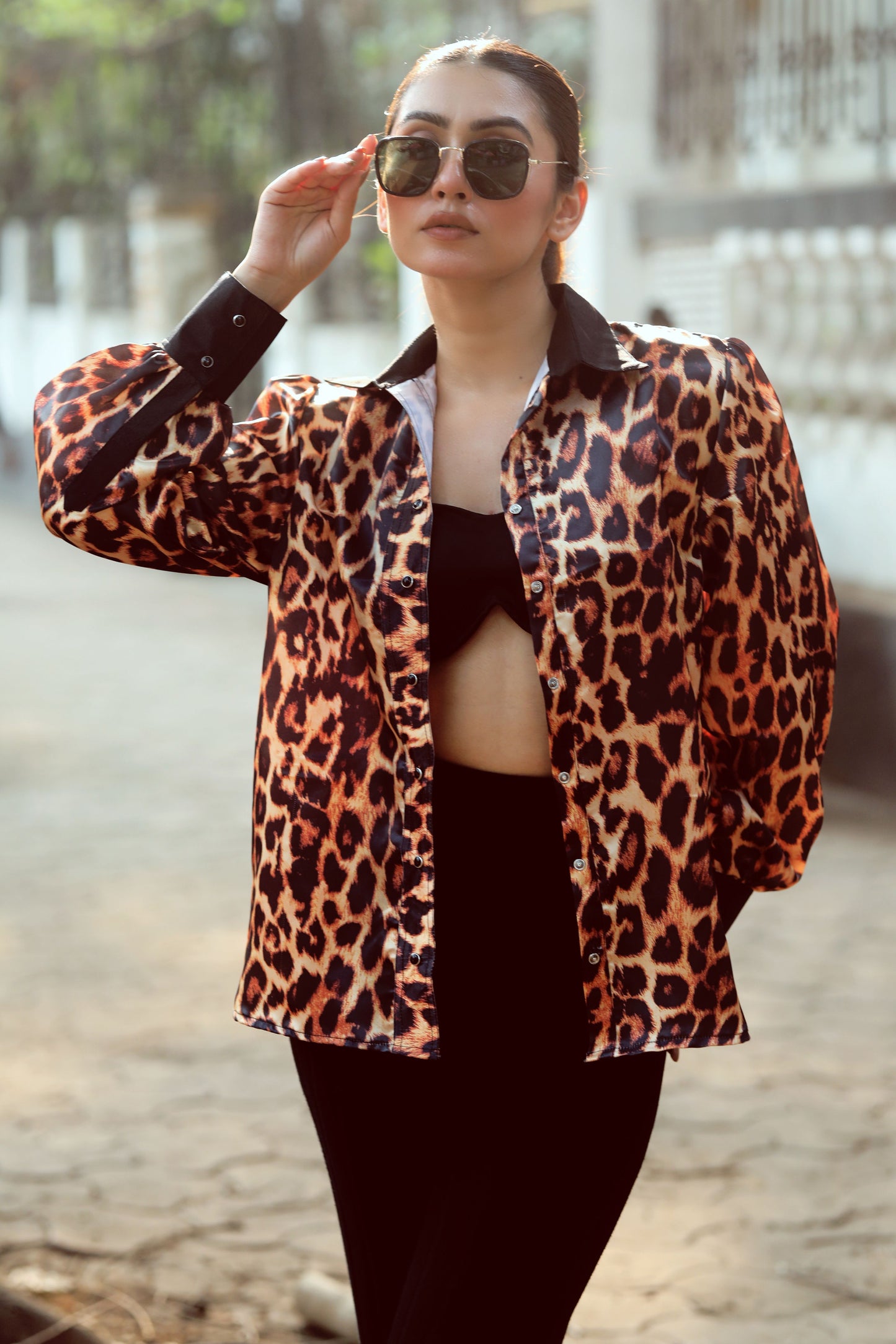 Black BOSS MOVE shirt by 66aura displayed on a hanger, featuring a sleek design with a collar and button-front detail.