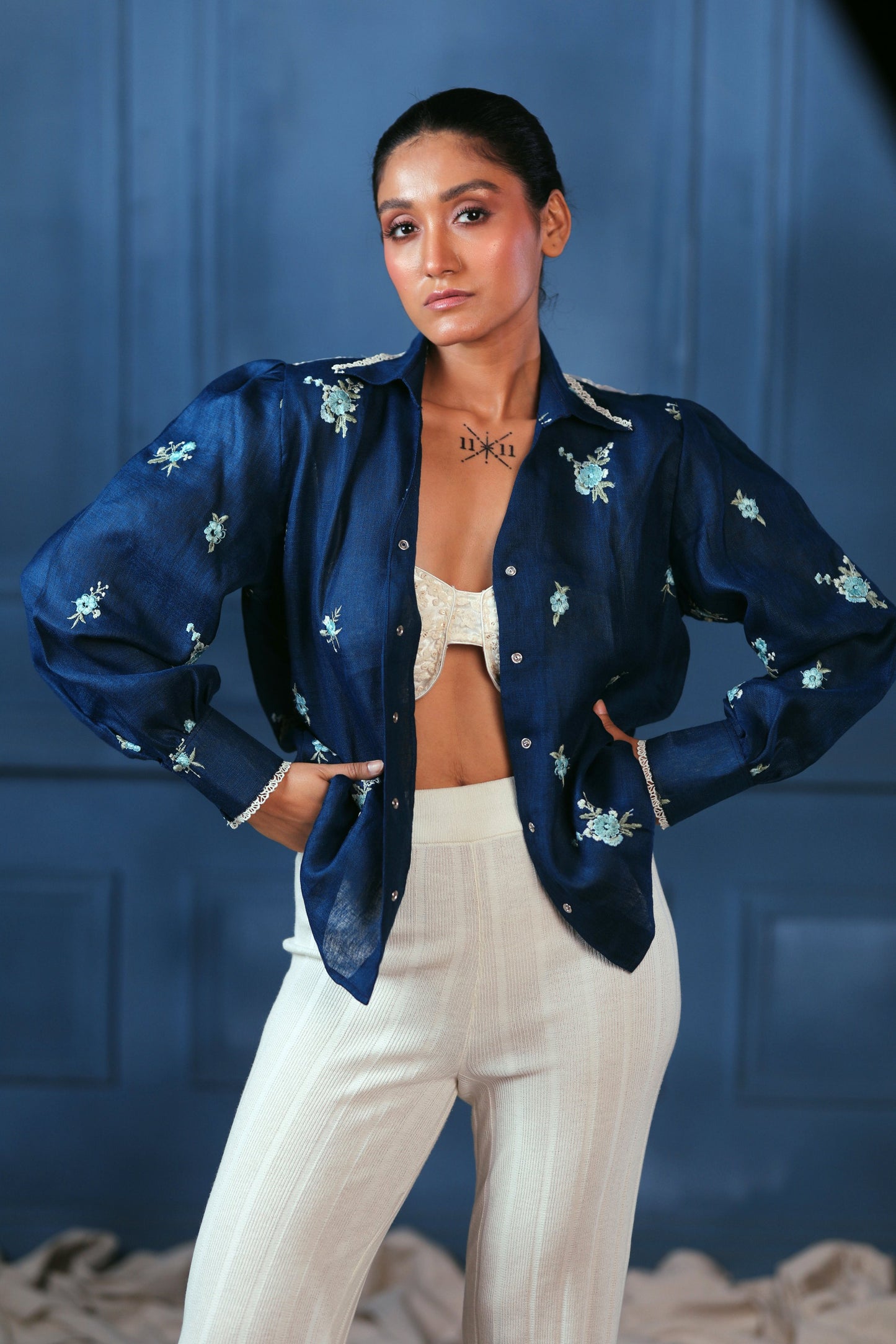 Navy Nexus oversized shirt by 66aura displayed on a hanger, featuring a relaxed fit and modern design for casual wear.