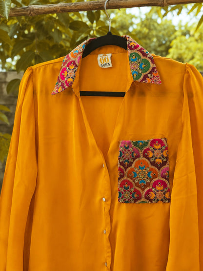 Sunny Side oversized shirt by 66aura, light and breezy cotton blouse with a relaxed fit and button-down front, styled on a hanger.