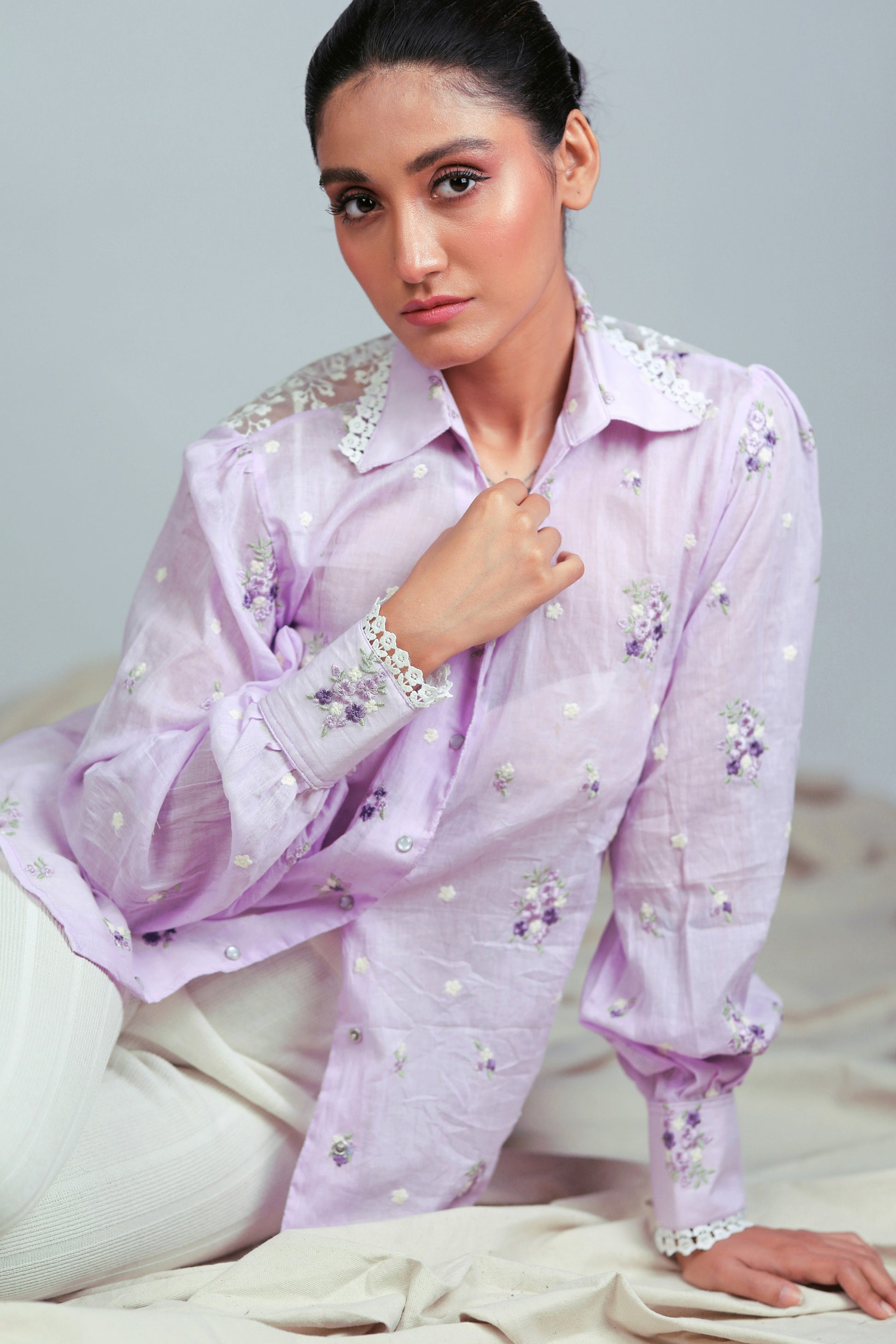Lilac Lagoon oversized shirt by 66aura displayed on a hanger, showcasing its relaxed fit and soft fabric in a light purple color.