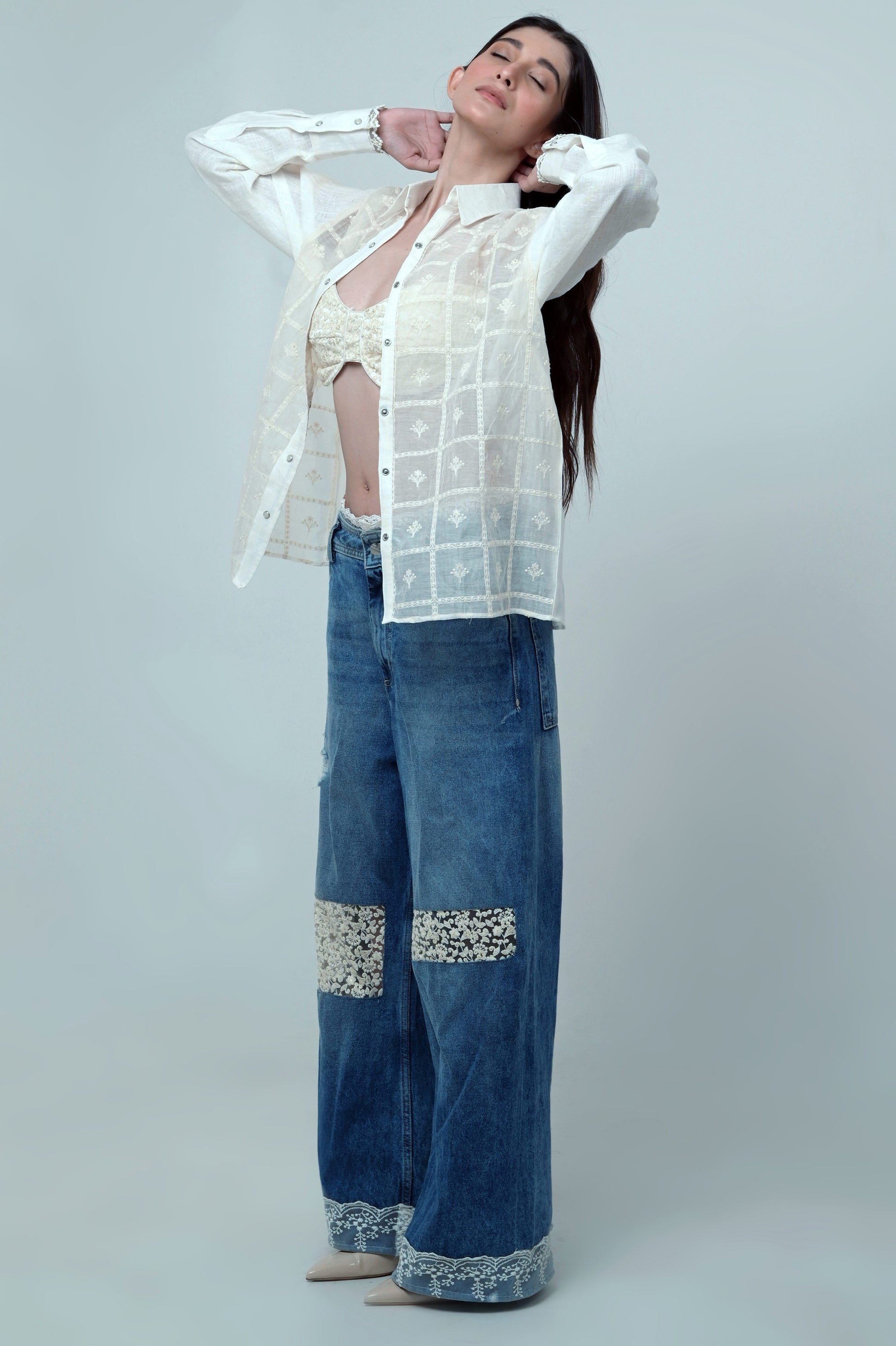 Light wash Vibe Check jeans by 66aura showing slim fit style with distressed details and classic five-pocket design.