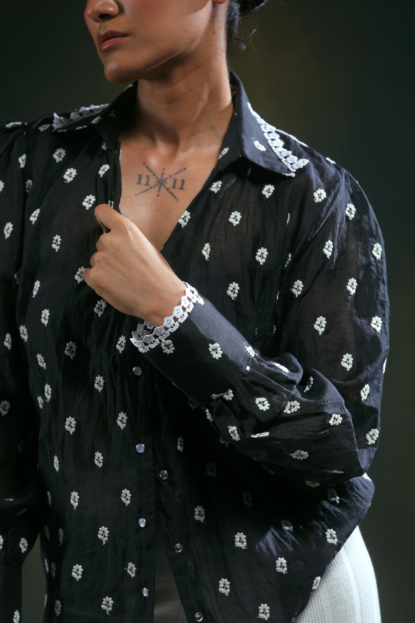 66aura Shadow Sync oversized shirt in black with a relaxed fit and long sleeves, displayed on a hanger.