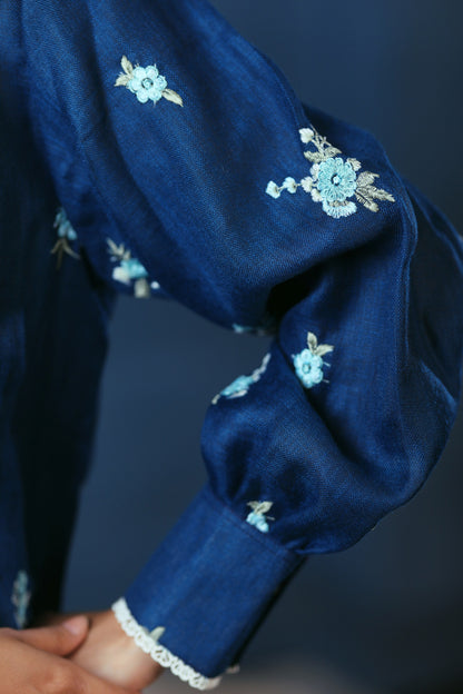 Navy Nexus oversized shirt by 66aura displayed on a hanger, featuring a relaxed fit and casual style.