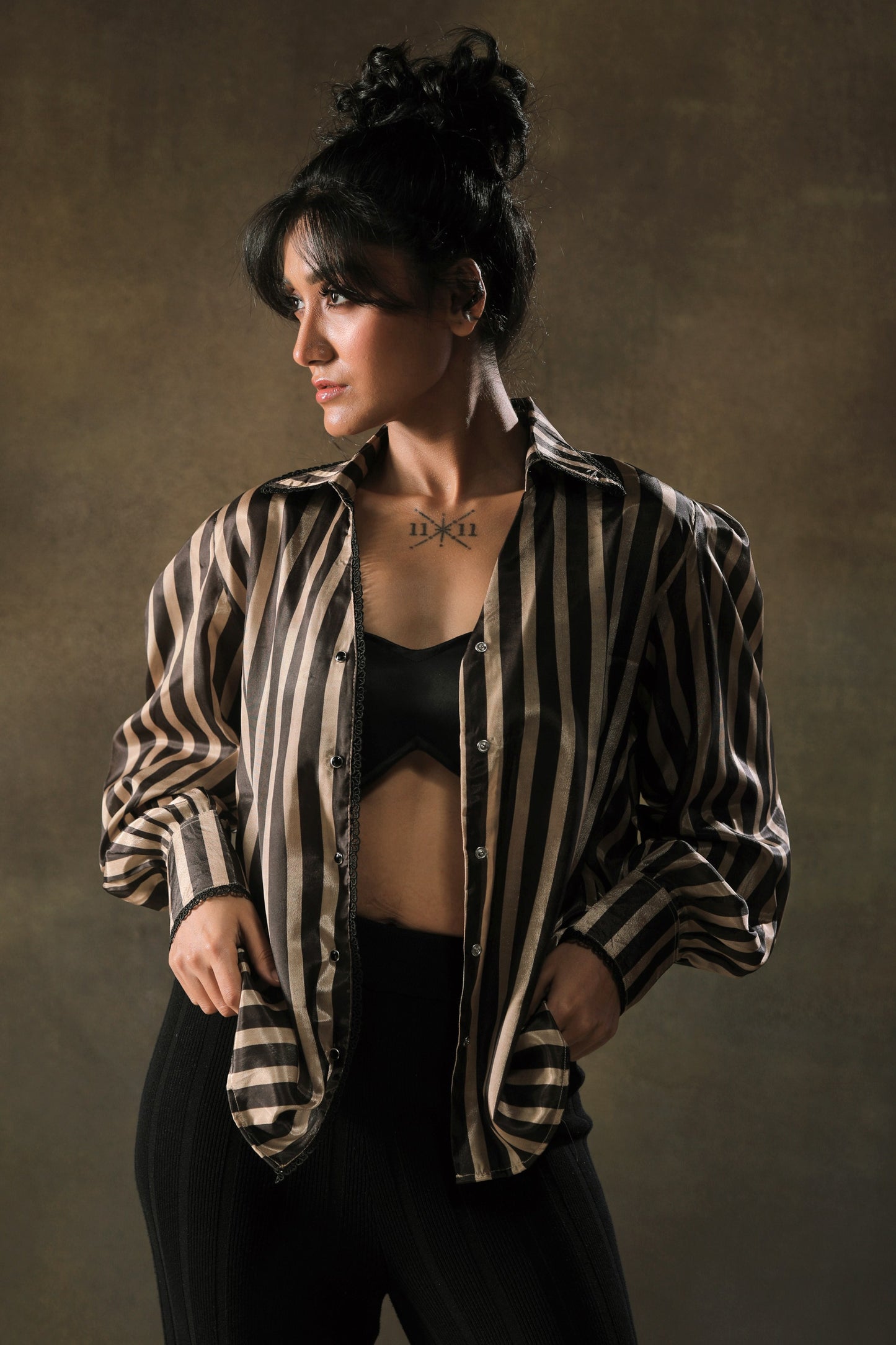 Oversized striped shirt by 66aura with bold horizontal stripes, relaxed fit, and long sleeves displayed on a hanger.