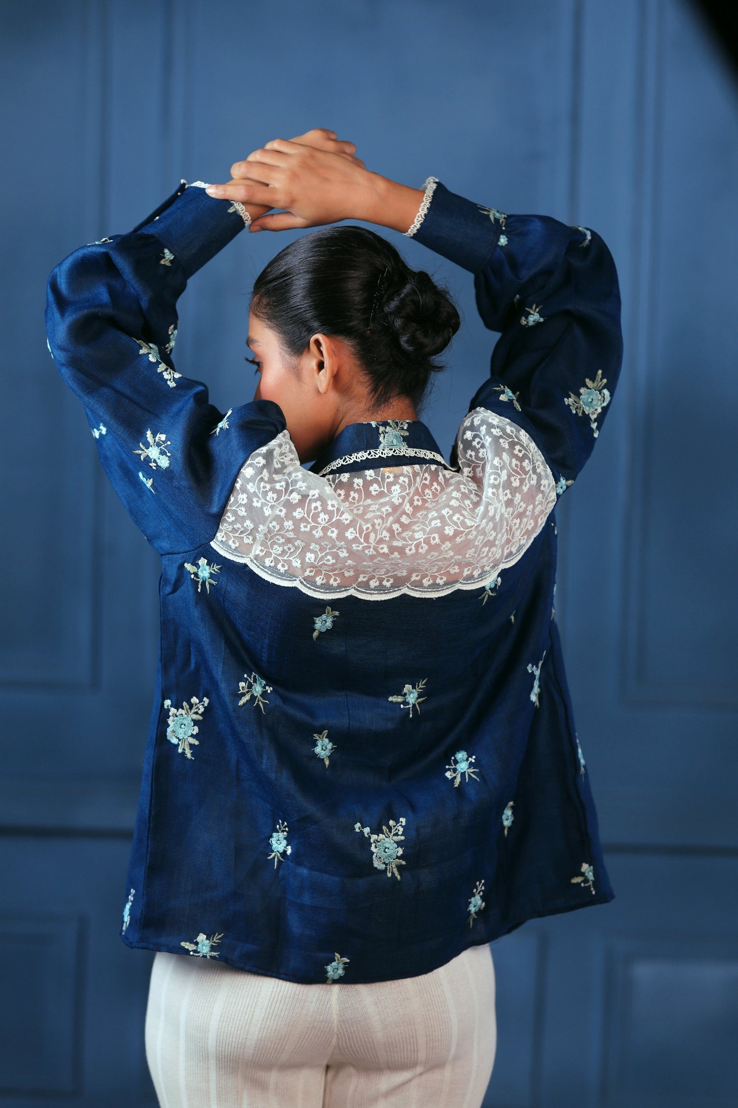 Navy Nexus oversized shirt by 66aura displayed on a hanger, featuring a relaxed fit and soft fabric for casual wear.