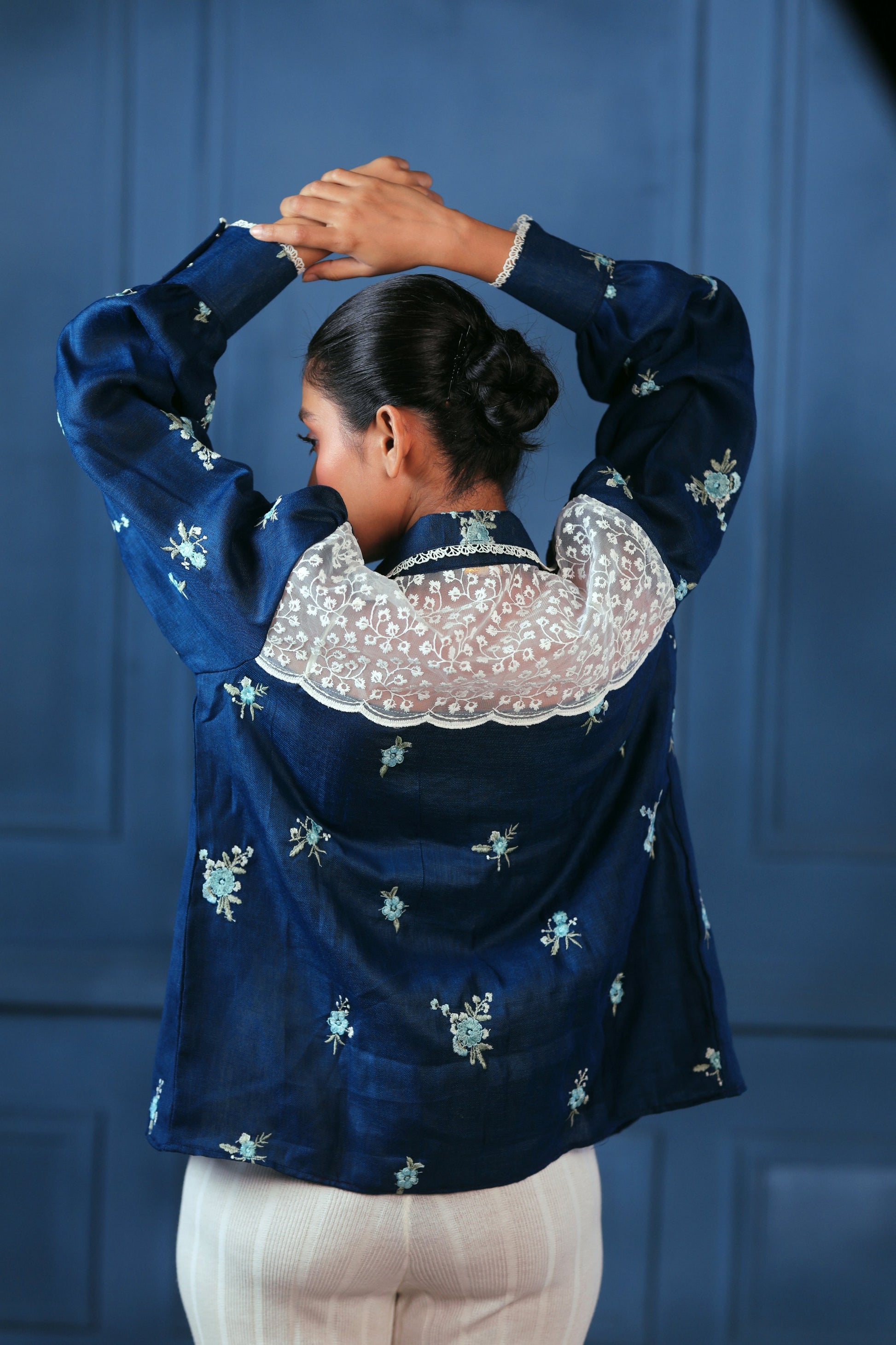 Navy Nexus oversized shirt by 66aura displayed on a hanger, featuring a relaxed fit and soft fabric for casual wear.