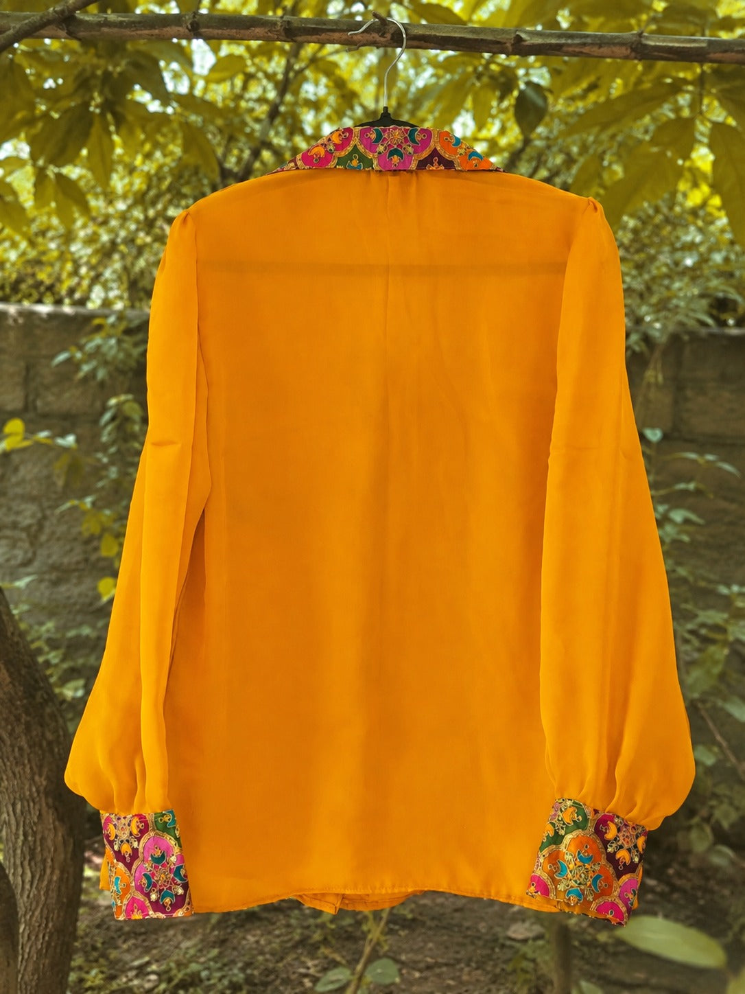 Oversized SUNNY SIDE shirt by 66aura in soft fabric with a relaxed fit and stylish design, displayed on a hanger.