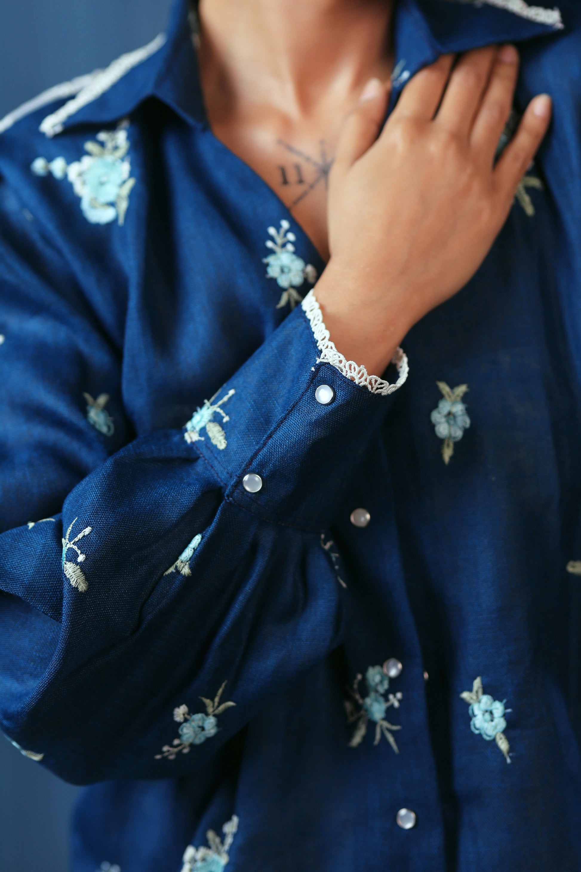 Navy Nexus oversized shirt by 66aura, featuring a relaxed fit with long sleeves and a button-up front, displayed on a hanger.