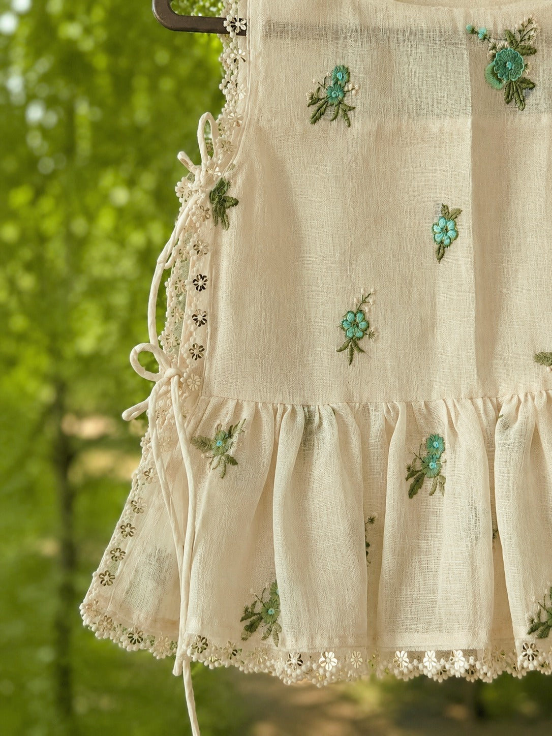66aura Monaco Muse Top displayed on a hanger, showcasing its stylish design and fabric texture.