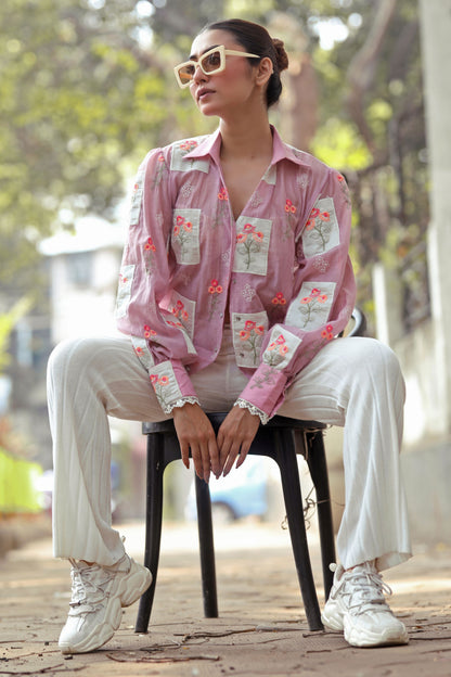 Lilac Loco Shirt by 66aura displayed on a hanger, showcasing the light purple color and casual fit of the stylish top.