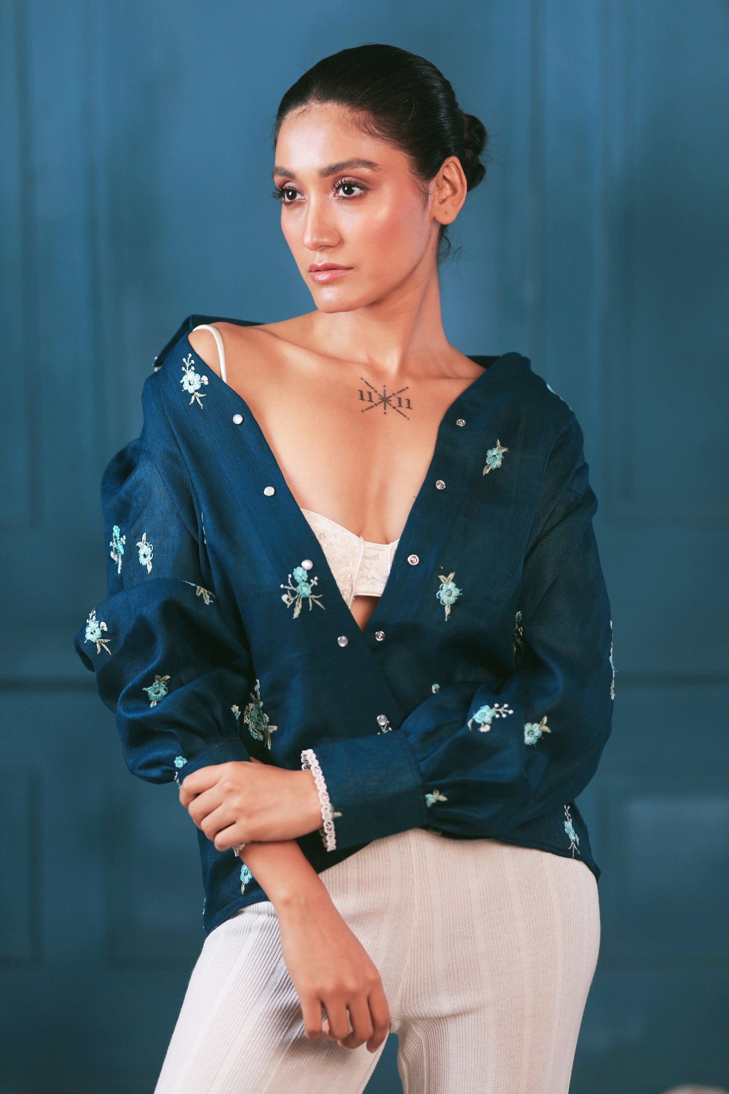 Navy Nexus oversized shirt by 66aura displayed on a hanger, featuring a relaxed fit and casual style.