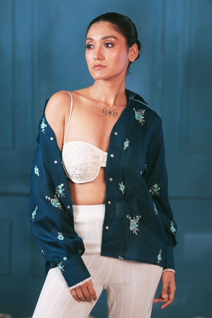 Navy Nexus oversized shirt by 66aura displayed on a hanger, featuring a relaxed fit with long sleeves and a classic collar.