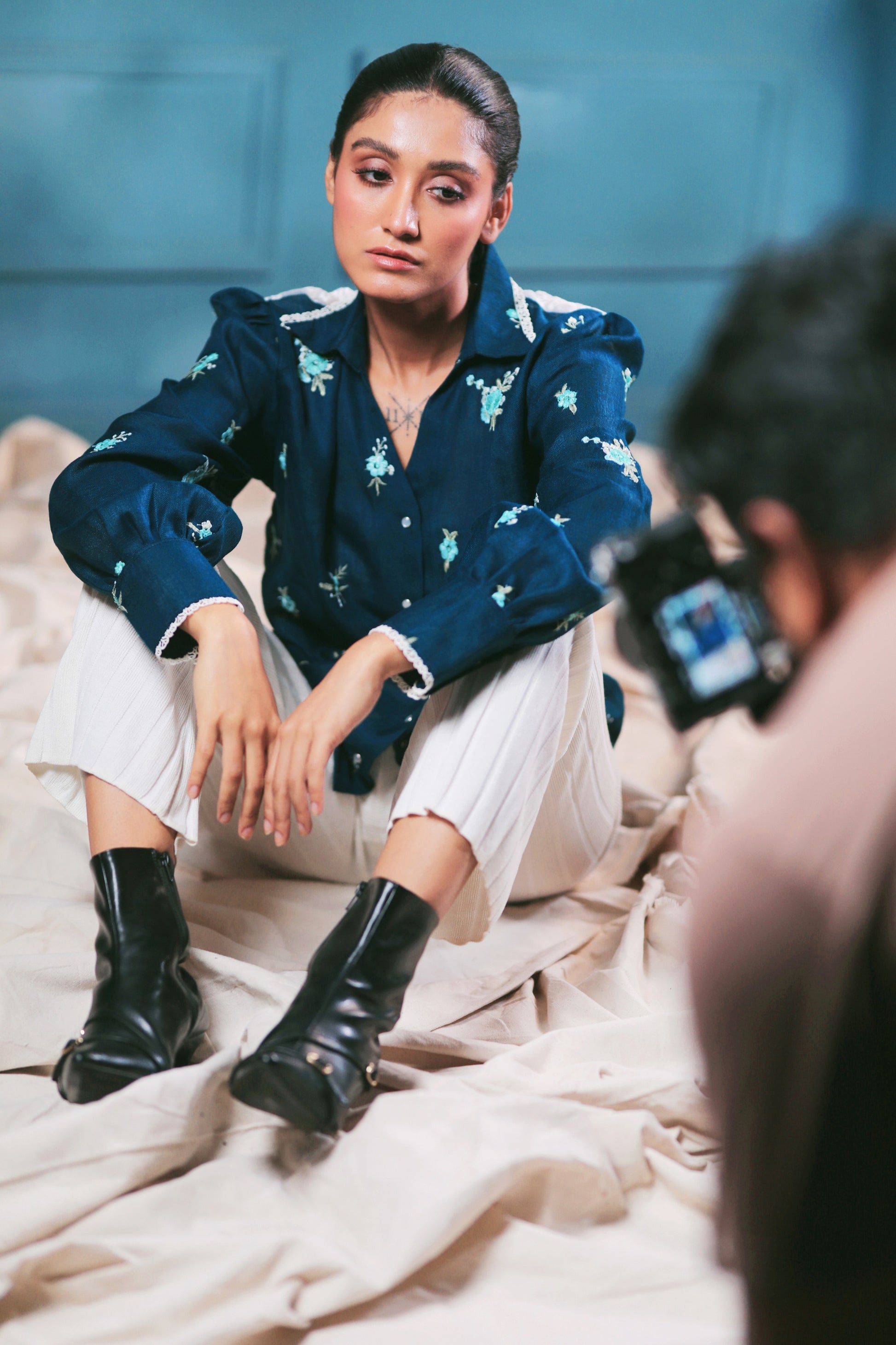 Navy Nexus oversized shirt by 66aura displayed on a hanger, featuring a relaxed fit and button-down front.