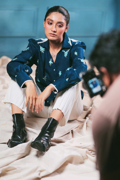 Navy Nexus oversized shirt by 66aura displayed on a hanger, featuring a relaxed fit and button-down front.