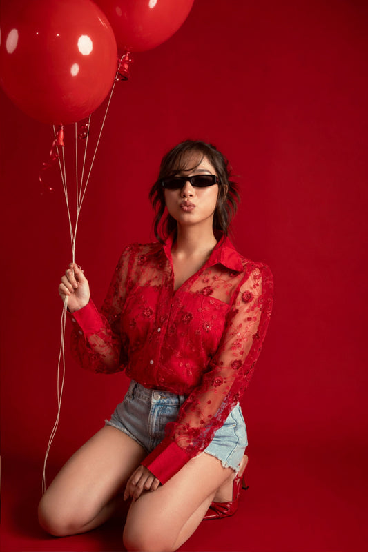 Model wearing a 66aura Kiss Code oversized shirt, styled with a carpet and props for a casual, relaxed look.