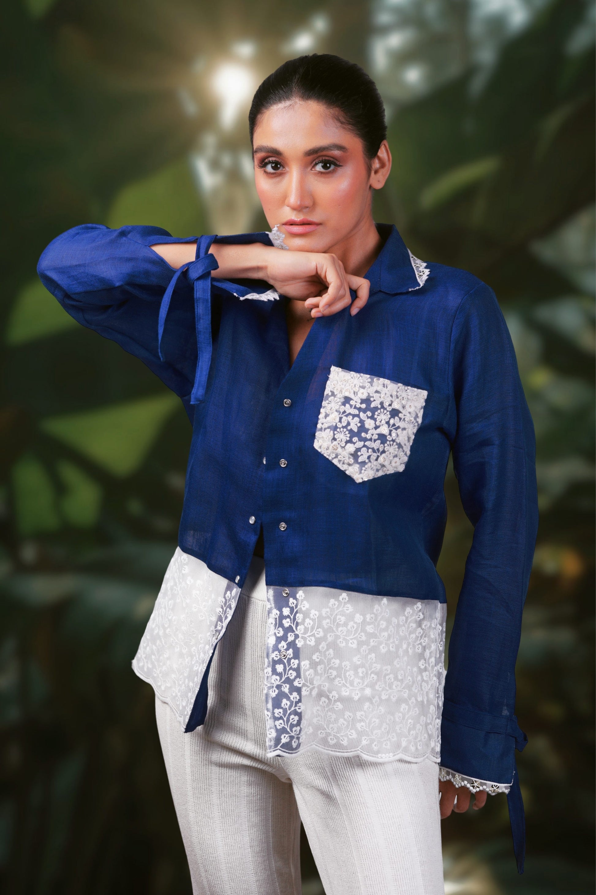 Model wearing a cobalt crush oversized shirt by 66aura, styled with a casual look on a carpeted background.