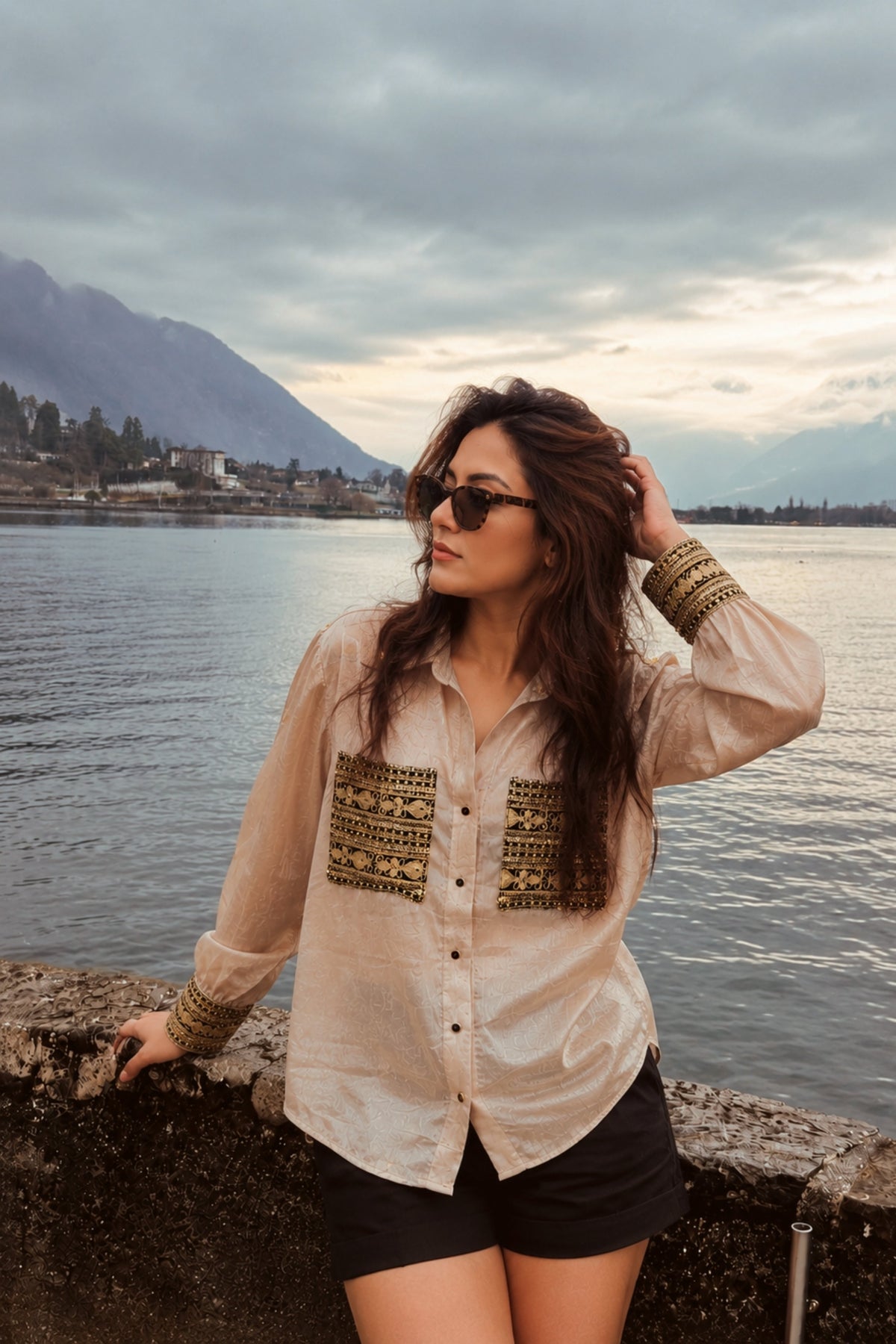 Model wearing the ethnic echo oversized shirt by 66aura, showcasing its relaxed fit with a textured fabric and vibrant ethnic patterns.
