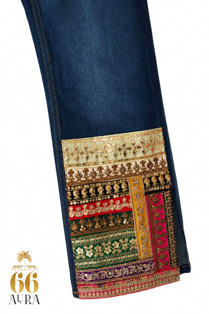 66aura Too Iconic jeans in a multicolor design displayed on a hanger with detailed stitching and fabric texture.