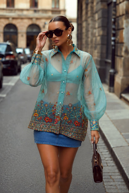 Sky blue oversized shirt with coastal carnival print by 66aura, featuring a relaxed fit and vibrant seaside-inspired design.