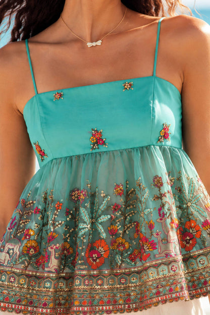 66aura Cannes Coast Top shown on a model, featuring a stylish, lightweight summer blouse with a relaxed fit and floral print.