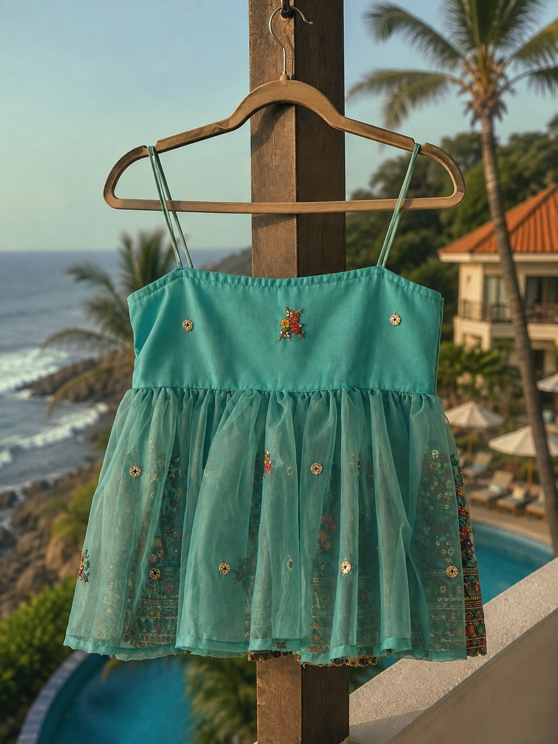 66aura Cannes Coast Top displayed on a hanger, featuring lightweight fabric and stylish design, ideal for casual summer wear.